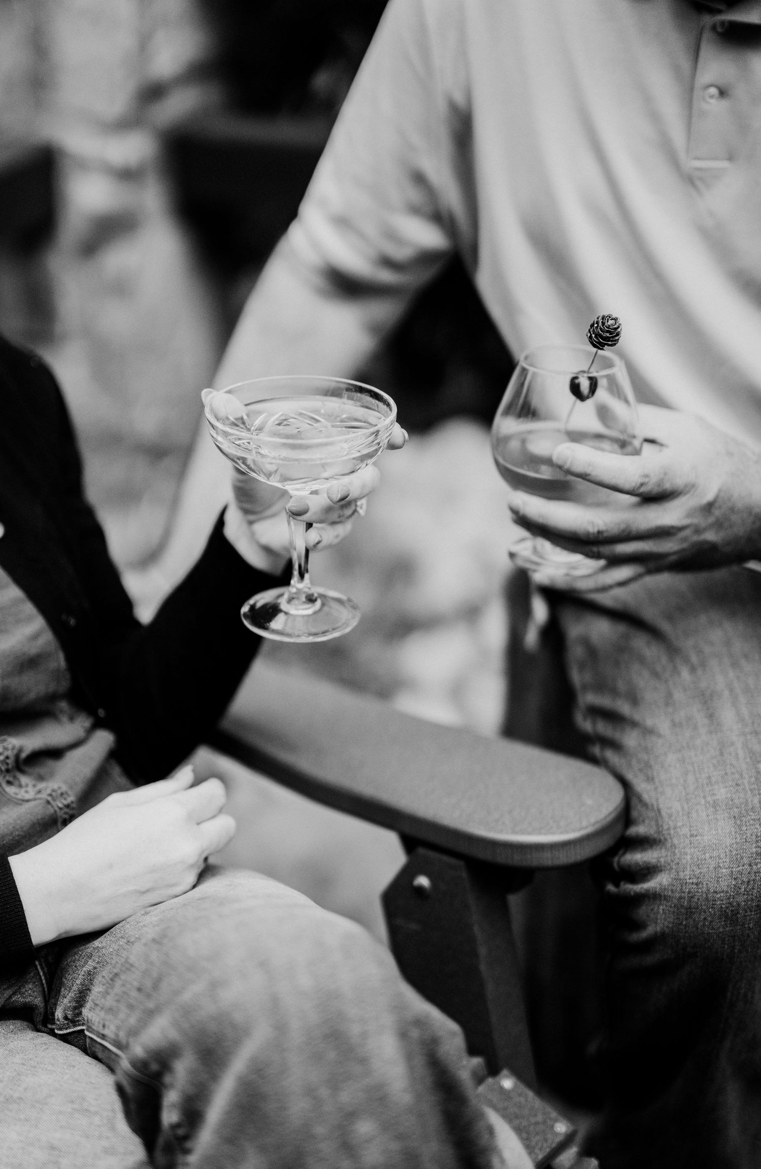 A black and white photo showing hands holding cocktail glasses at greenbrier restaurant in Gatlinburg, TN