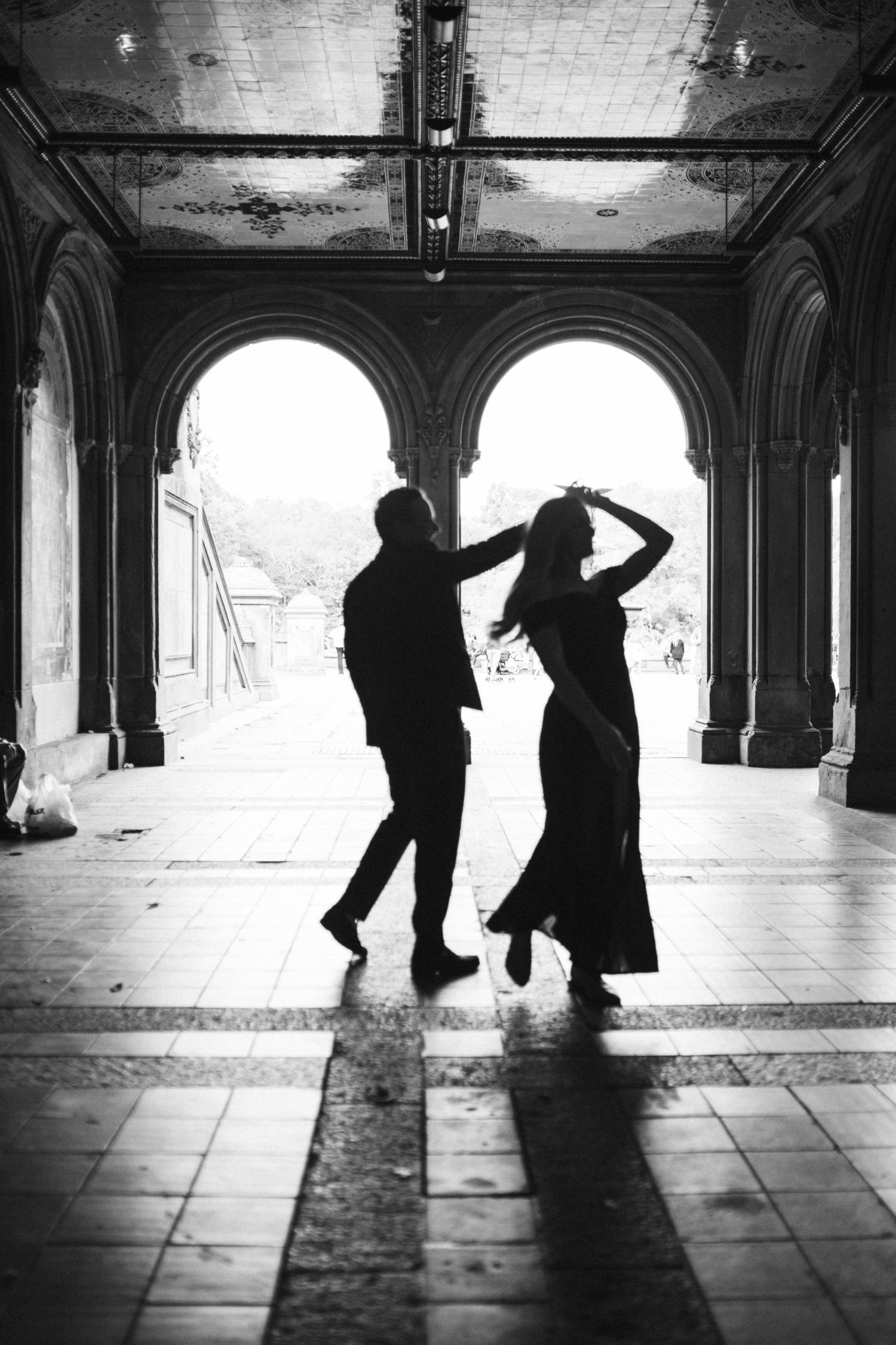 Dramatic black and white sequence capturing dancing silhouettes in ornate architectural space.