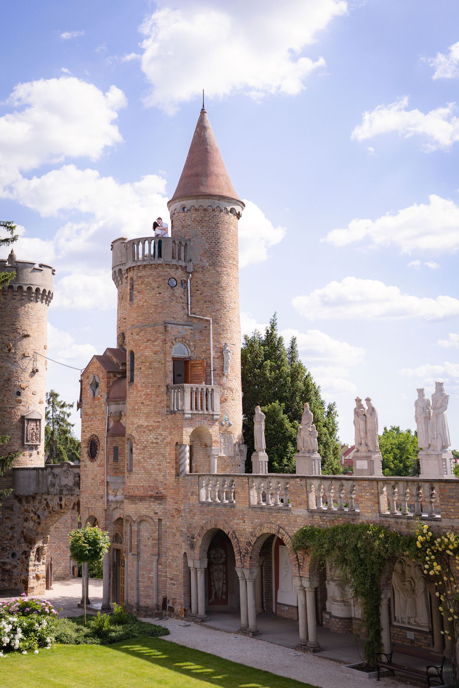 Medieval castle exterior with orange towers, battlements and decorative stonework.
