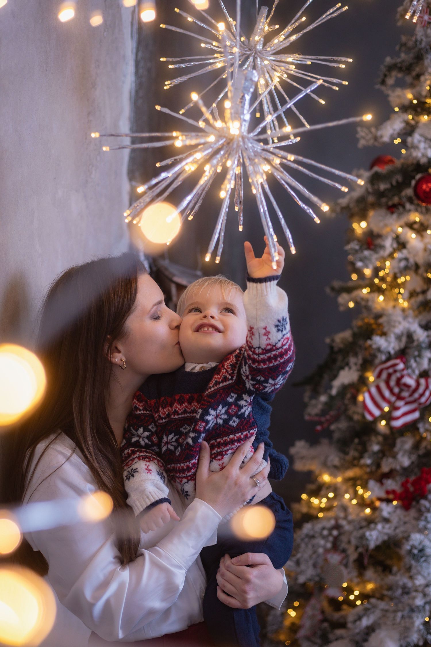 Holiday celebration with sparklers and Christmas tree lights creating a magical atmosphere.