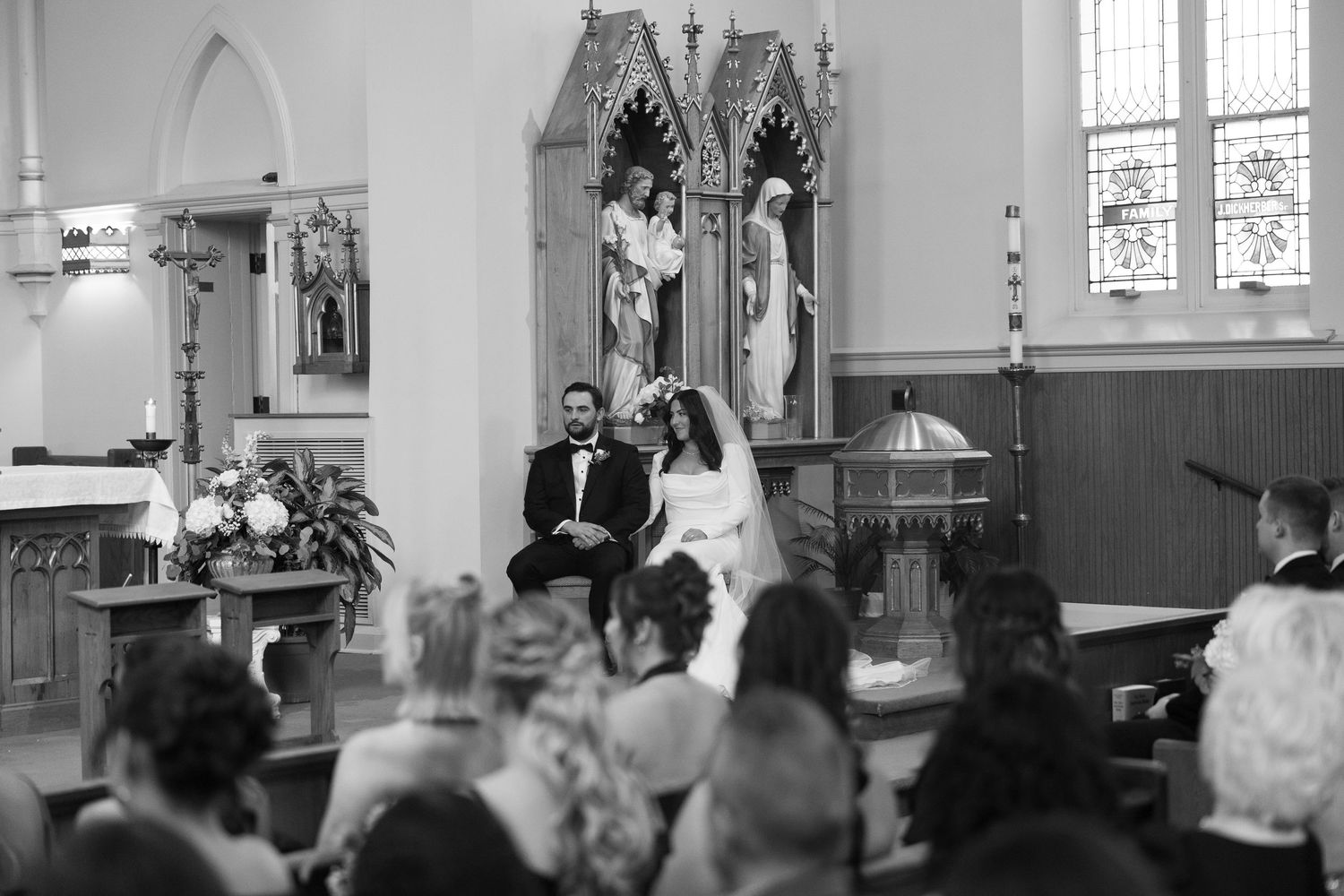 Black and white photo of church wedding ceremony with architectural details visible.