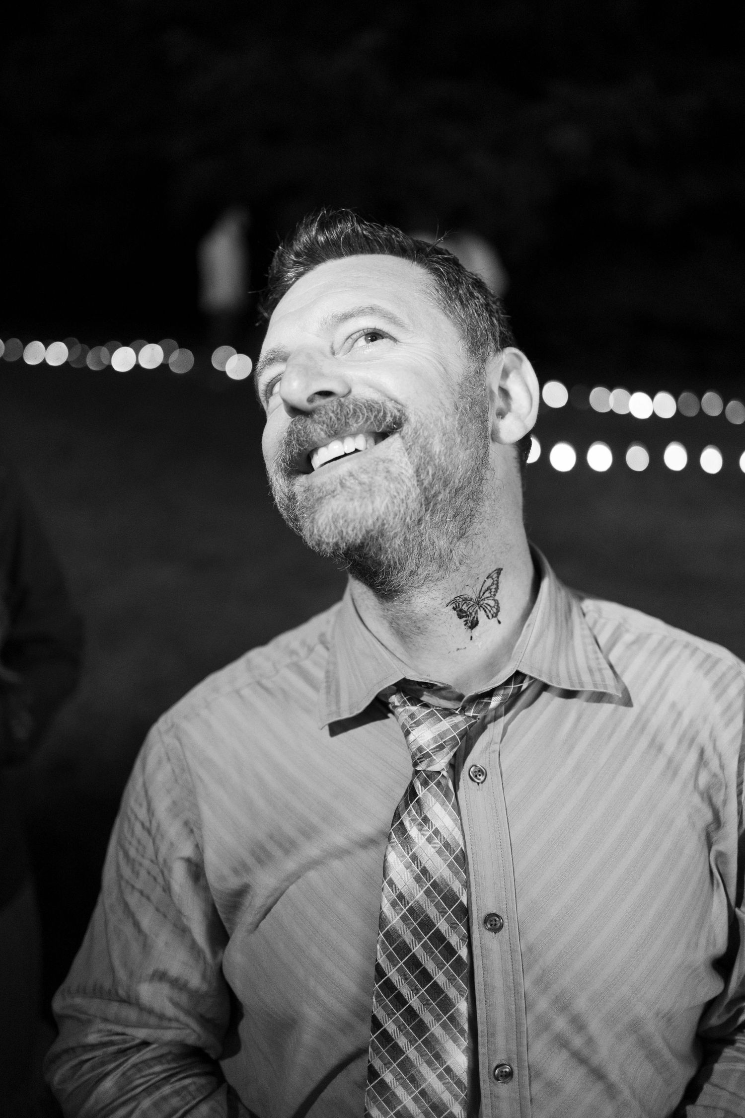 Black and white portrait series showing details of a person's beard and plaid tie in close-up shots.
