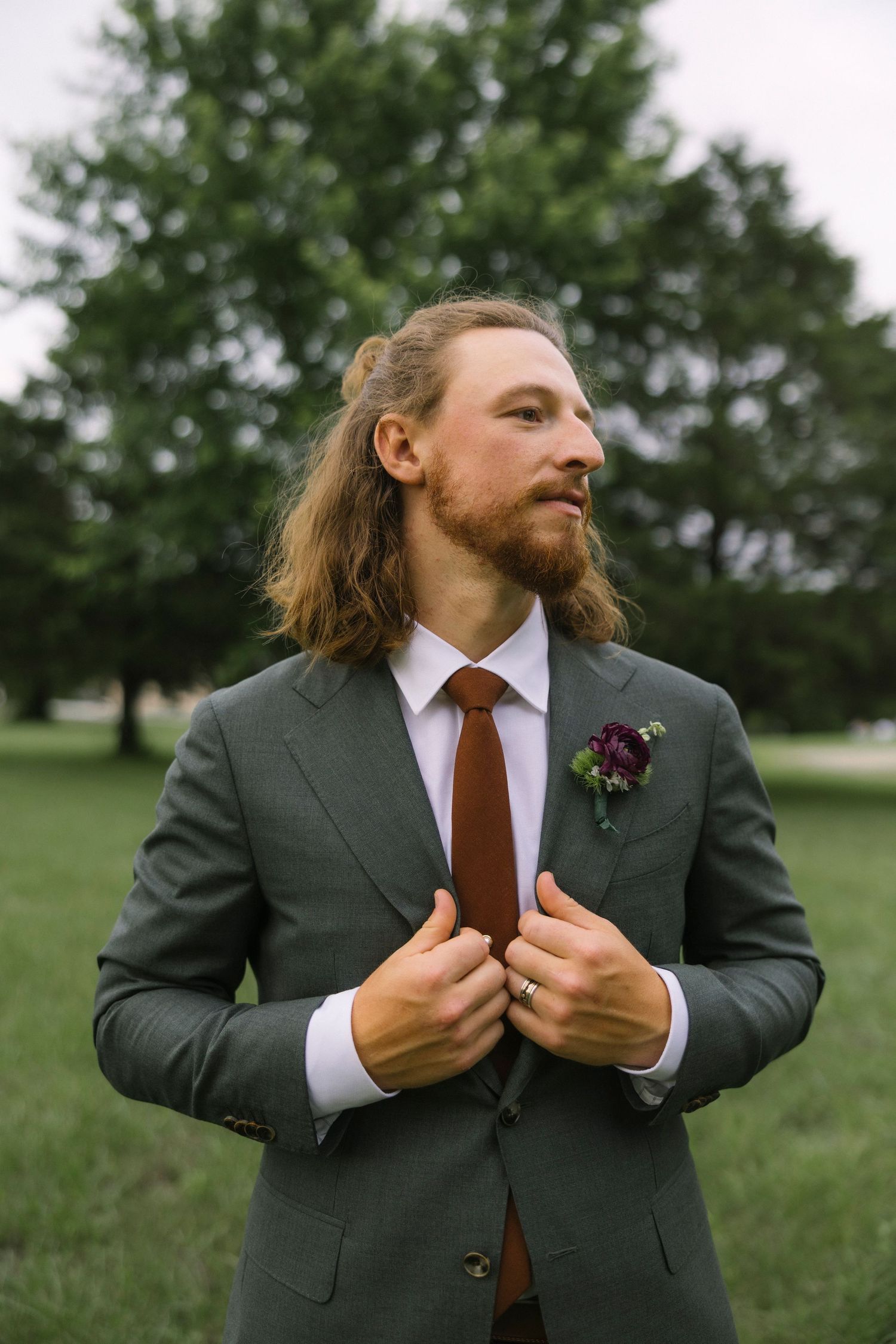 Groom in grey suit and brown tie adjusting his jacket in a series of candid outdoor shots.
