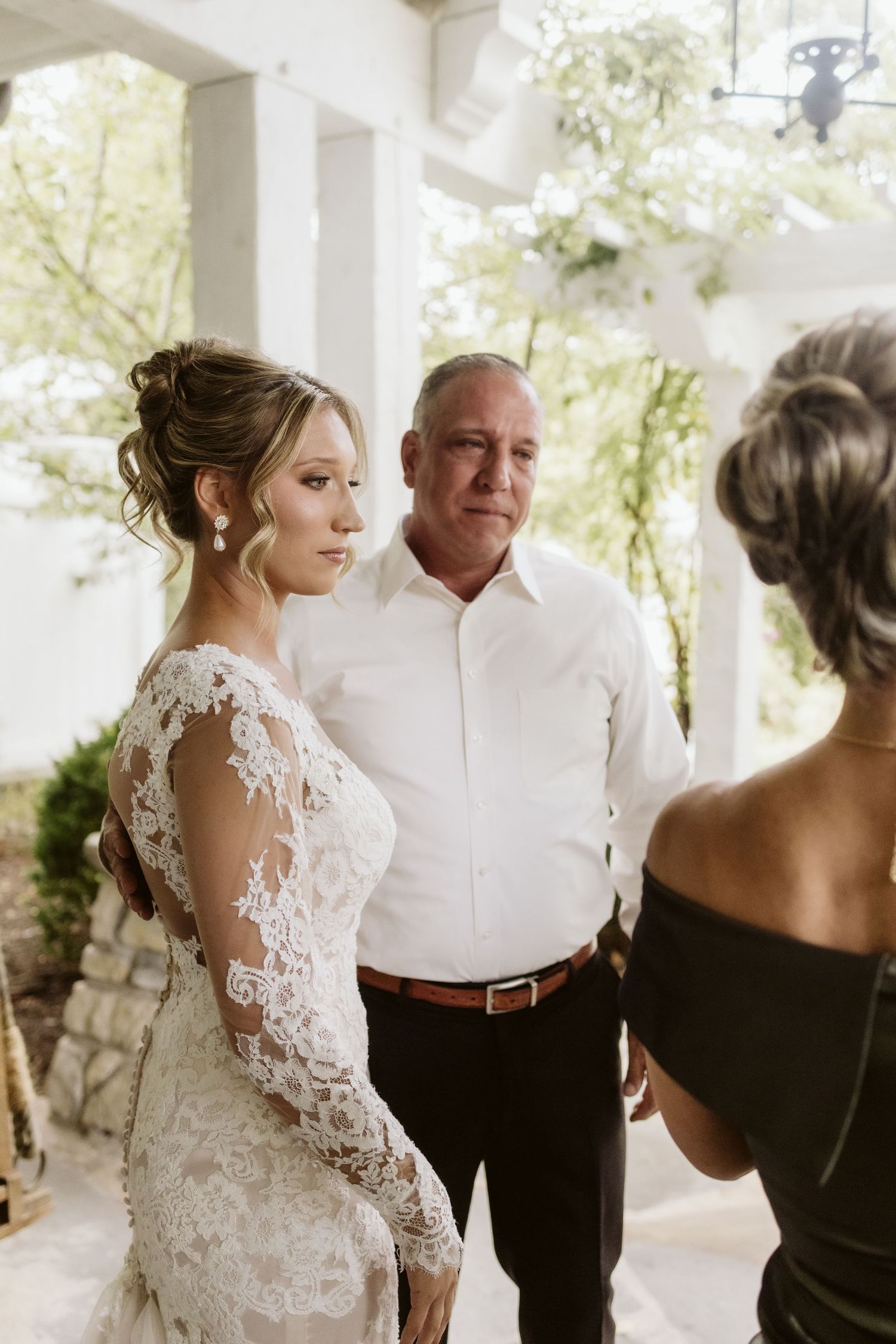Intimate moments captured on a white columned porch before the wedding ceremony.