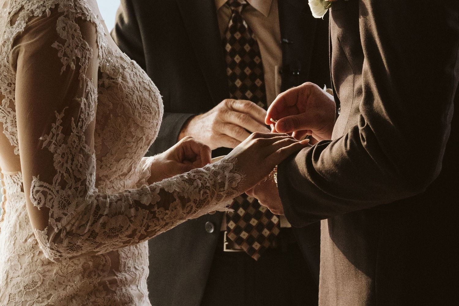 Close-up shot of a couple exchanging rings during their wedding ceremony.