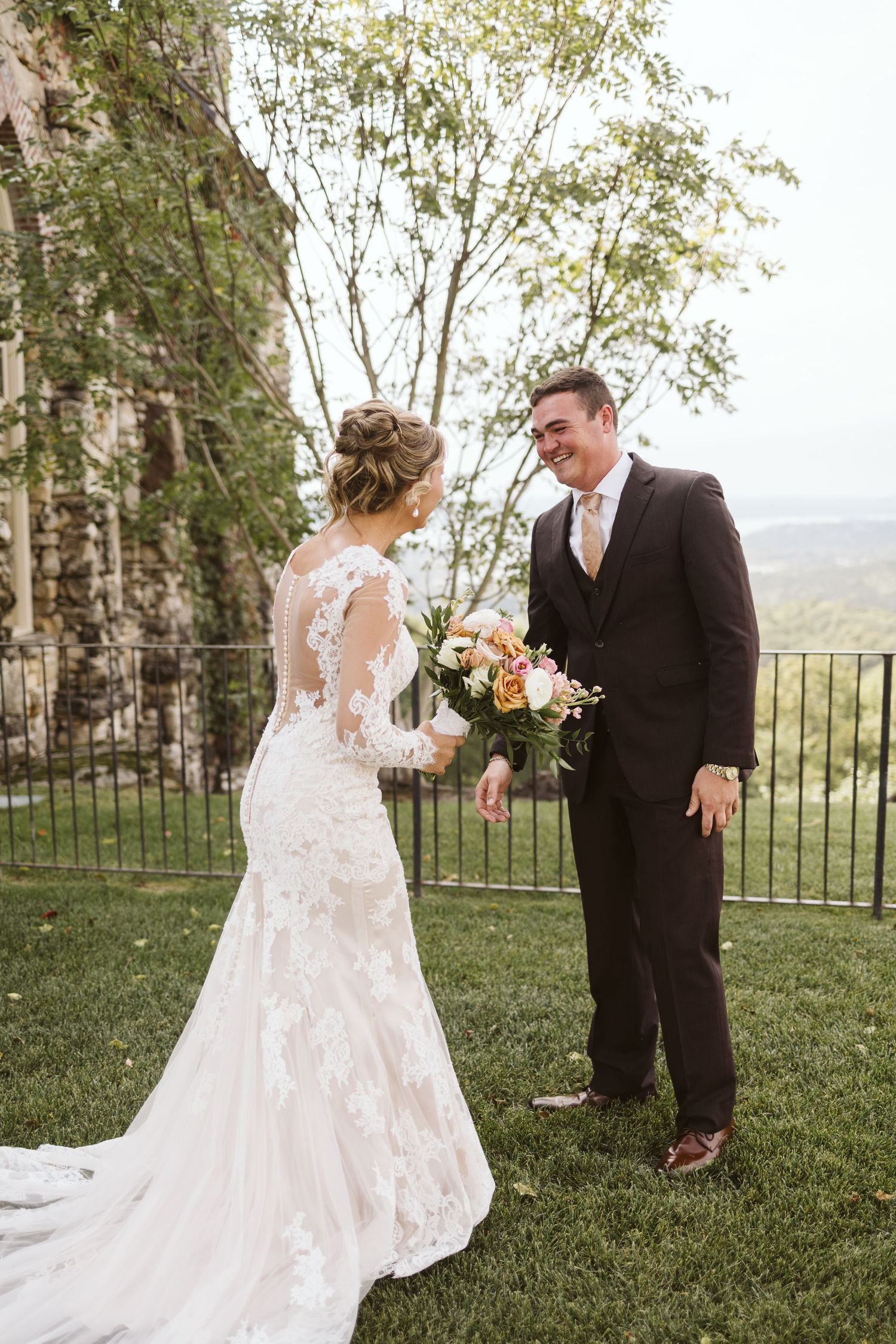 A couple shares their first look moment outdoors with scenic mountain views.