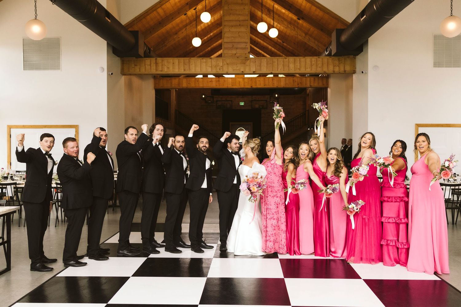 A panoramic wedding photo collage showing bridesmaids in pink dresses and groomsmen in black suits lined up at a venue.