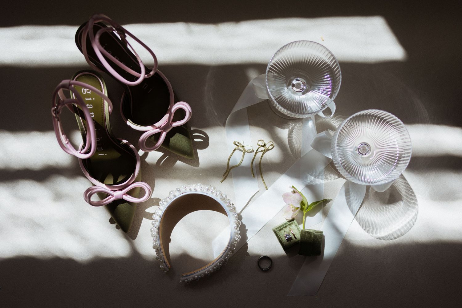 A black and white artistic wedding photo showing wine glasses and wedding decor with soft focusing effects.