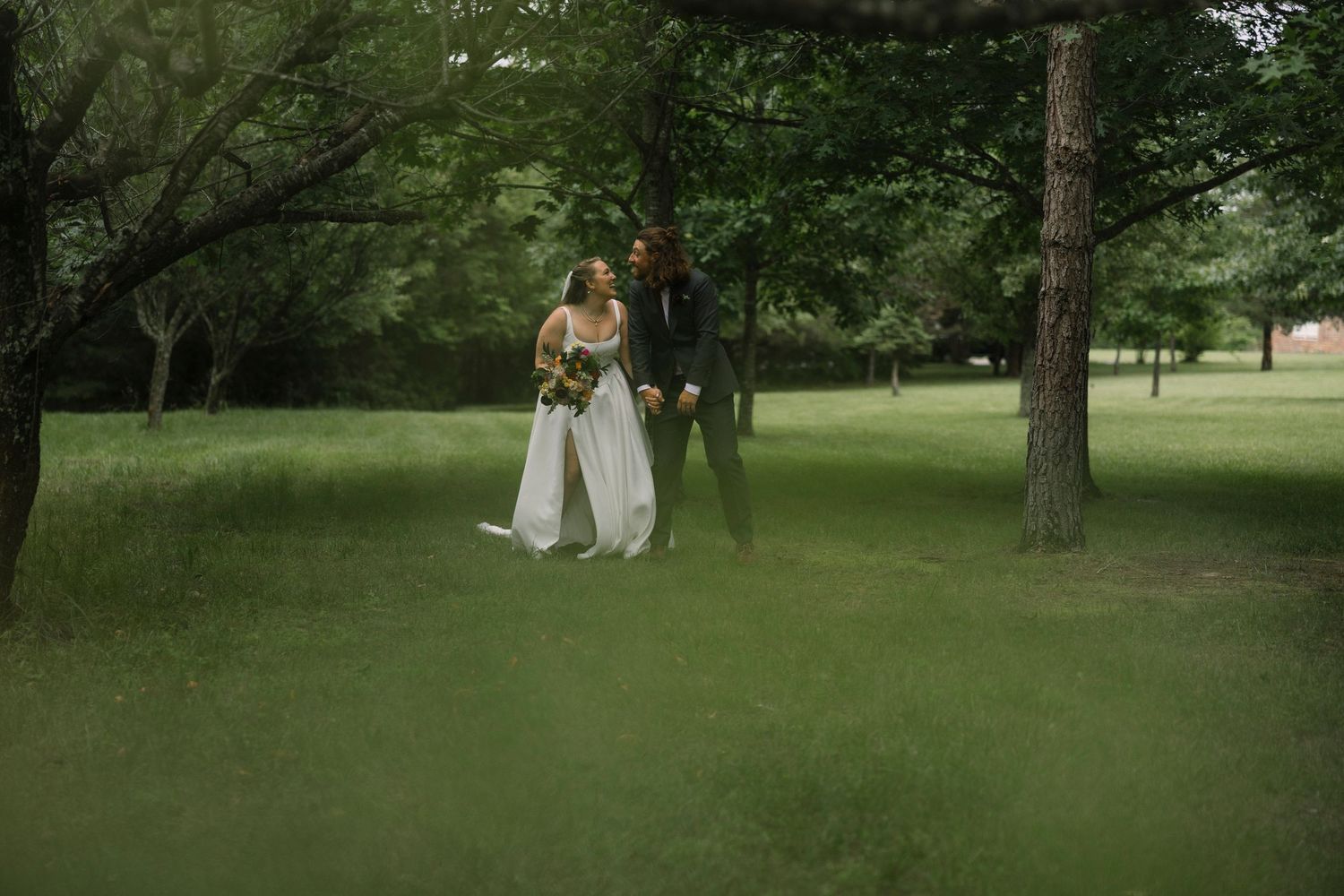 Elegant bridal photography amidst a scenic green park setting on a summer afternoon.