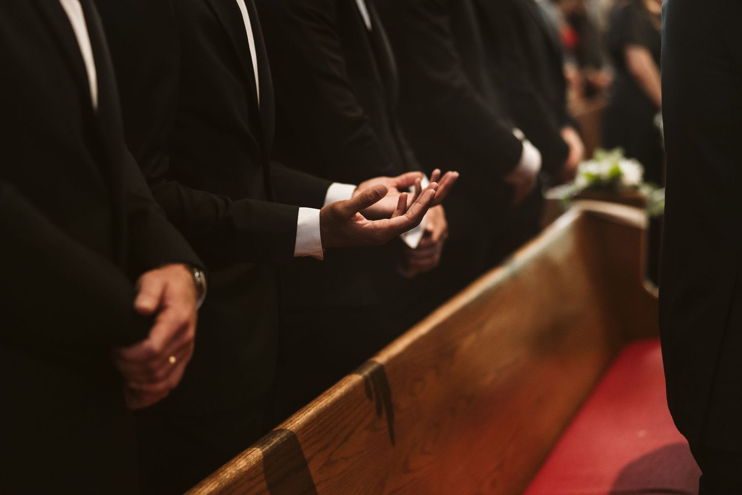 Close-up of hands during wedding ceremony in church setting.