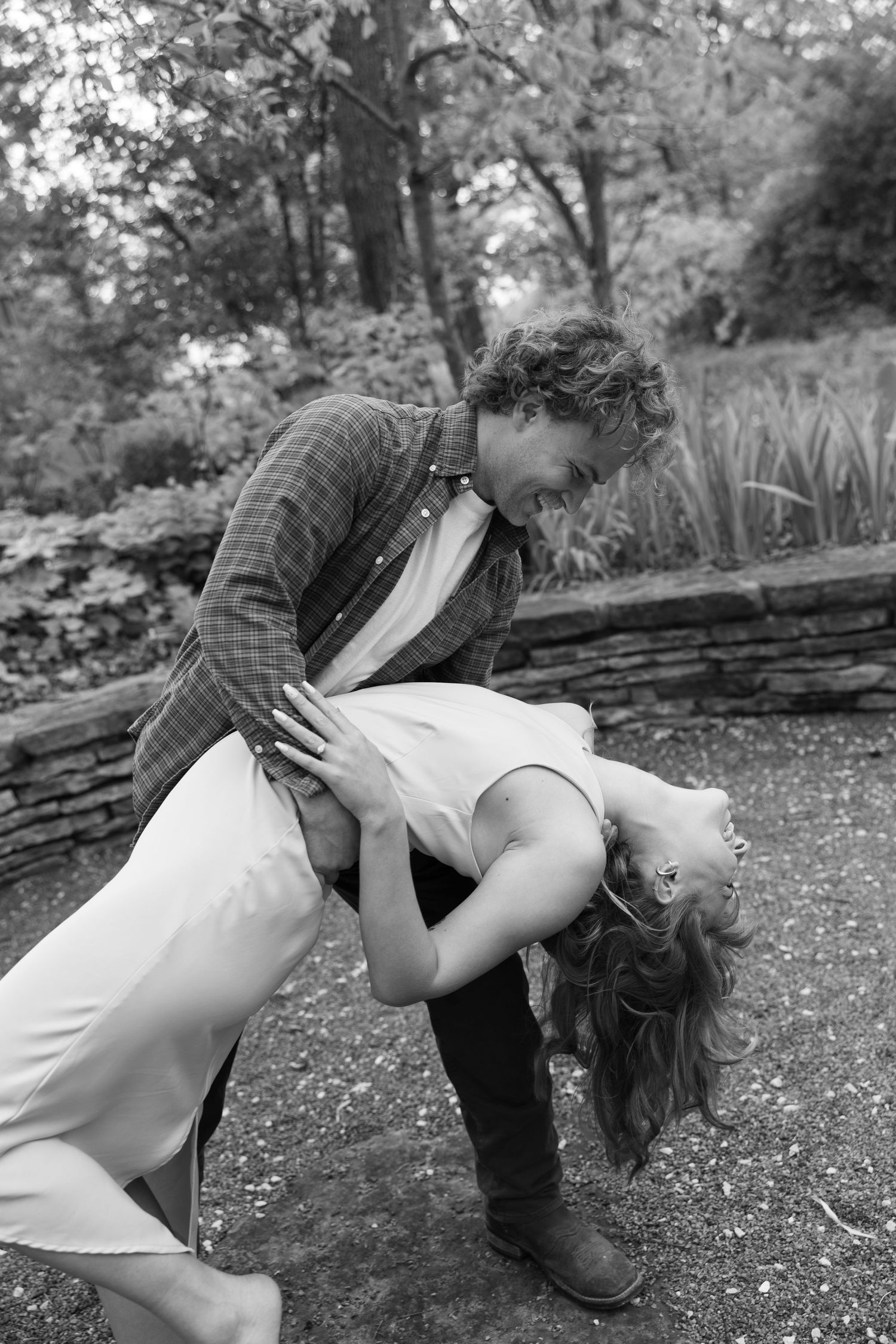 A dramatic black and white photo series showing intimate poses on stone ground.