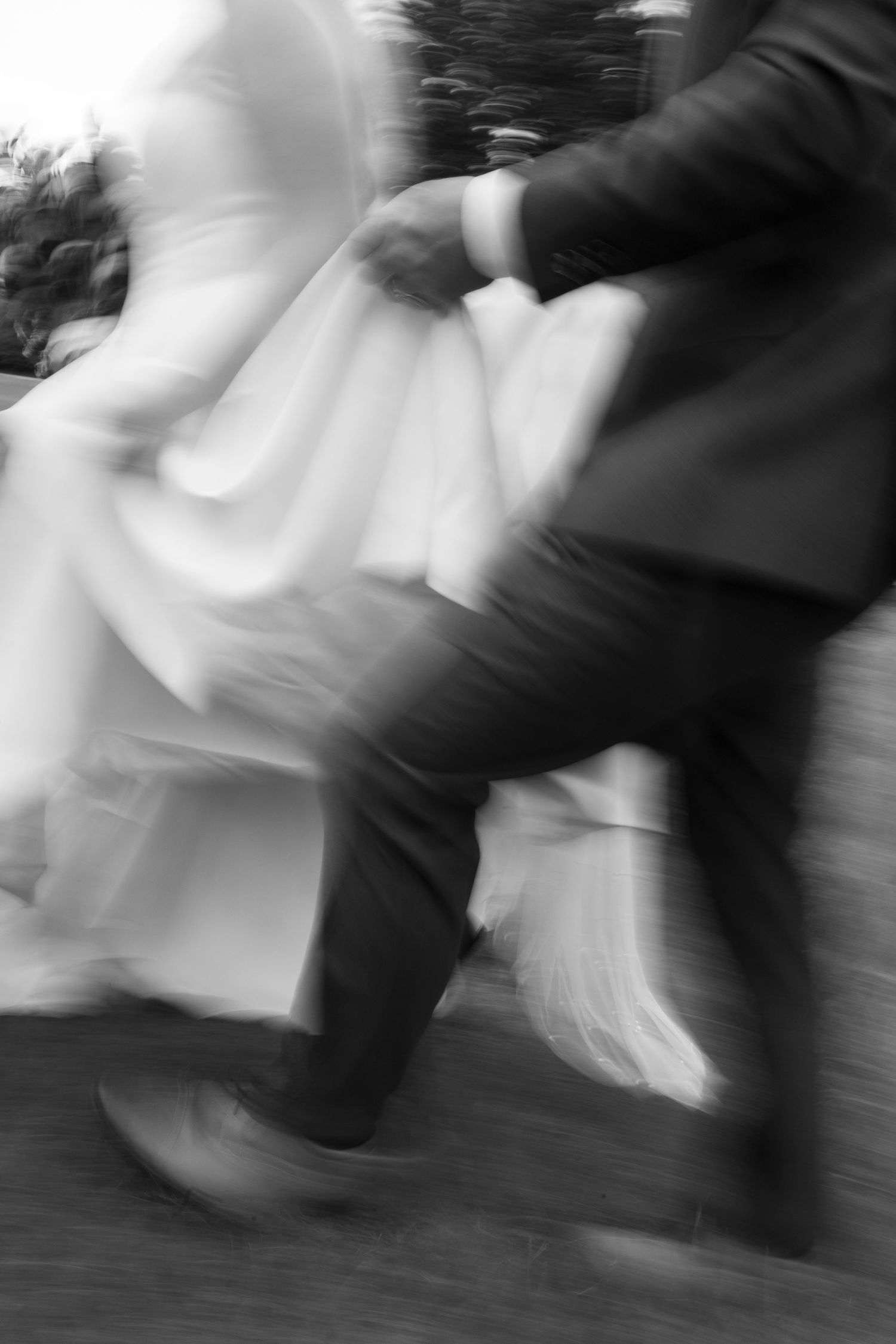 An artistic motion-blur capture of a couple dancing at their wedding.