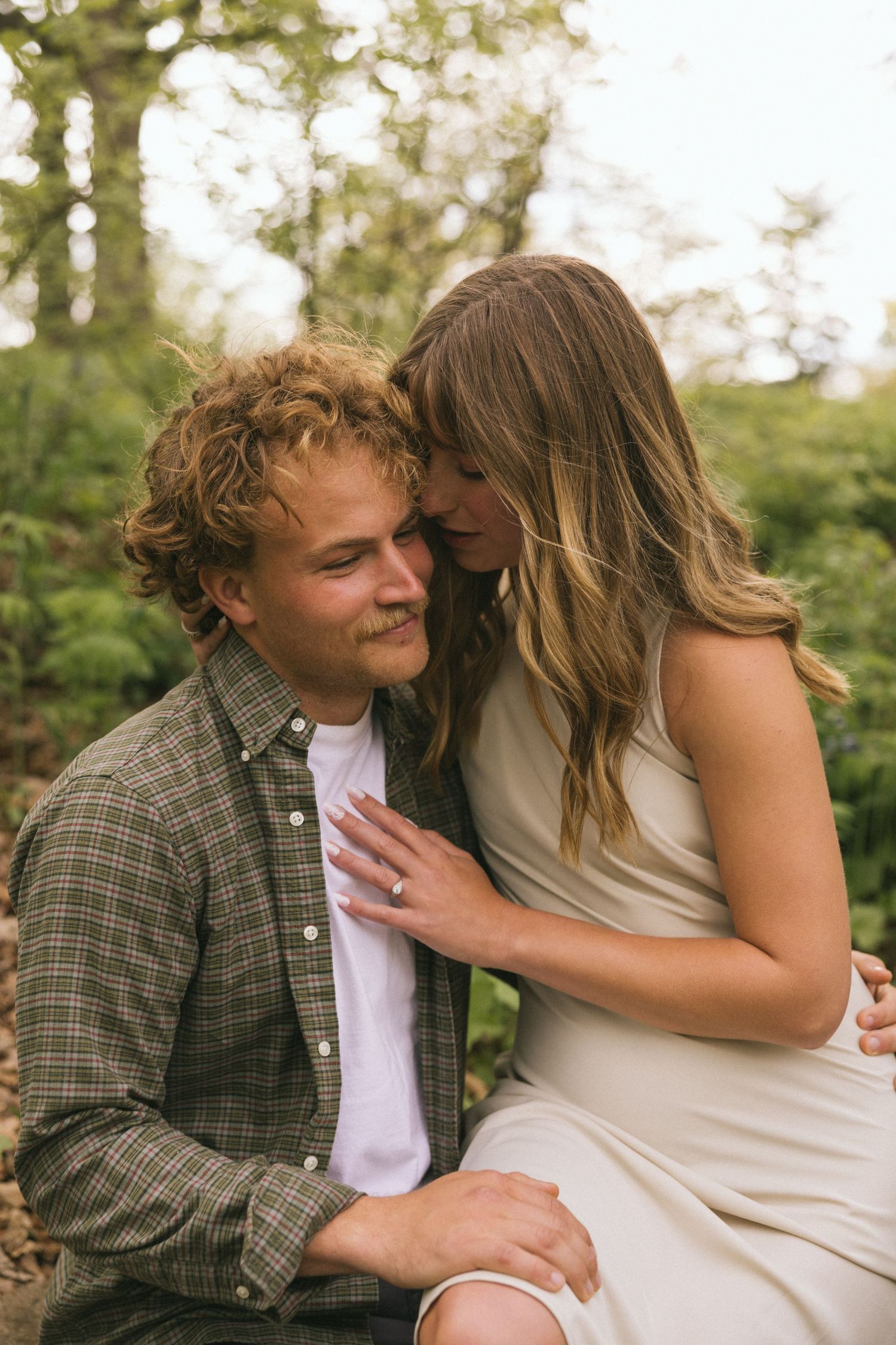 An intimate moment shared between a couple in a natural outdoor setting.