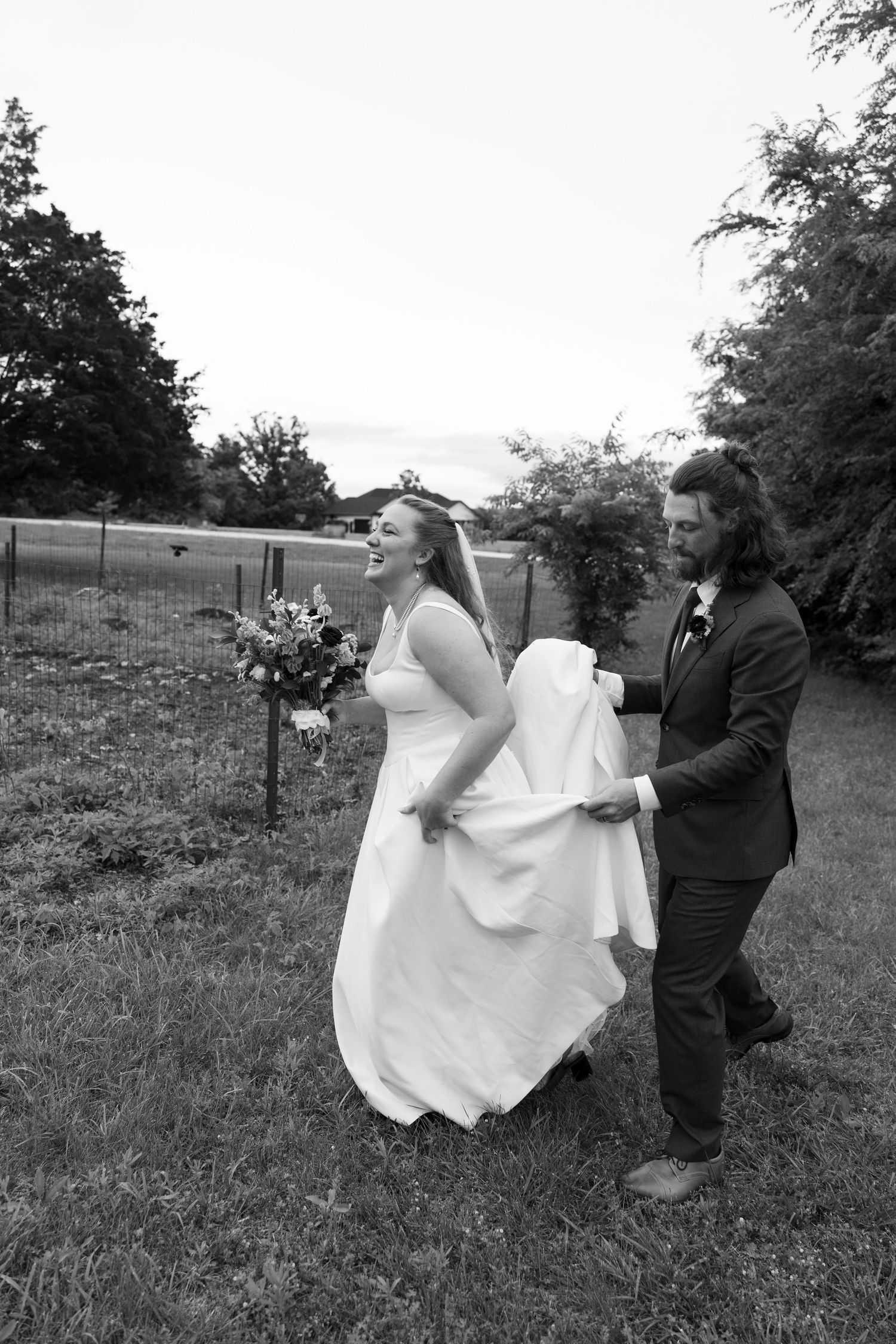 A sequence of black and white photos showing a couple in wedding attire playfully interacting in a grassy field.
