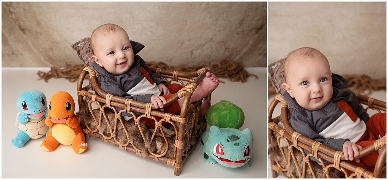 Baby in wicker basket surrounded by colorful stuffed Pokemon plush toys including Squirtle, Charmander and Bulbasaur.