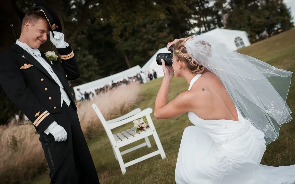 Wedding couple sharing romantic moments in a garden with white chairs.