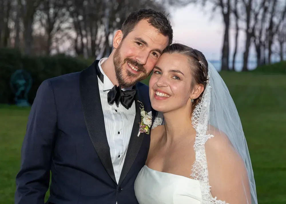 A newlywed couple shares joyful moments together during their outdoor spring wedding.
