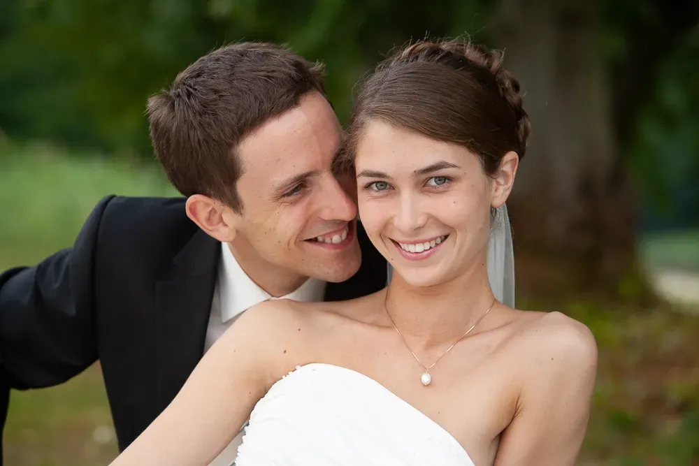 Intimate wedding moment captured in a lush garden setting.