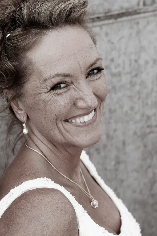 Black and white portrait series capturing joyful expressions and genuine smiles.