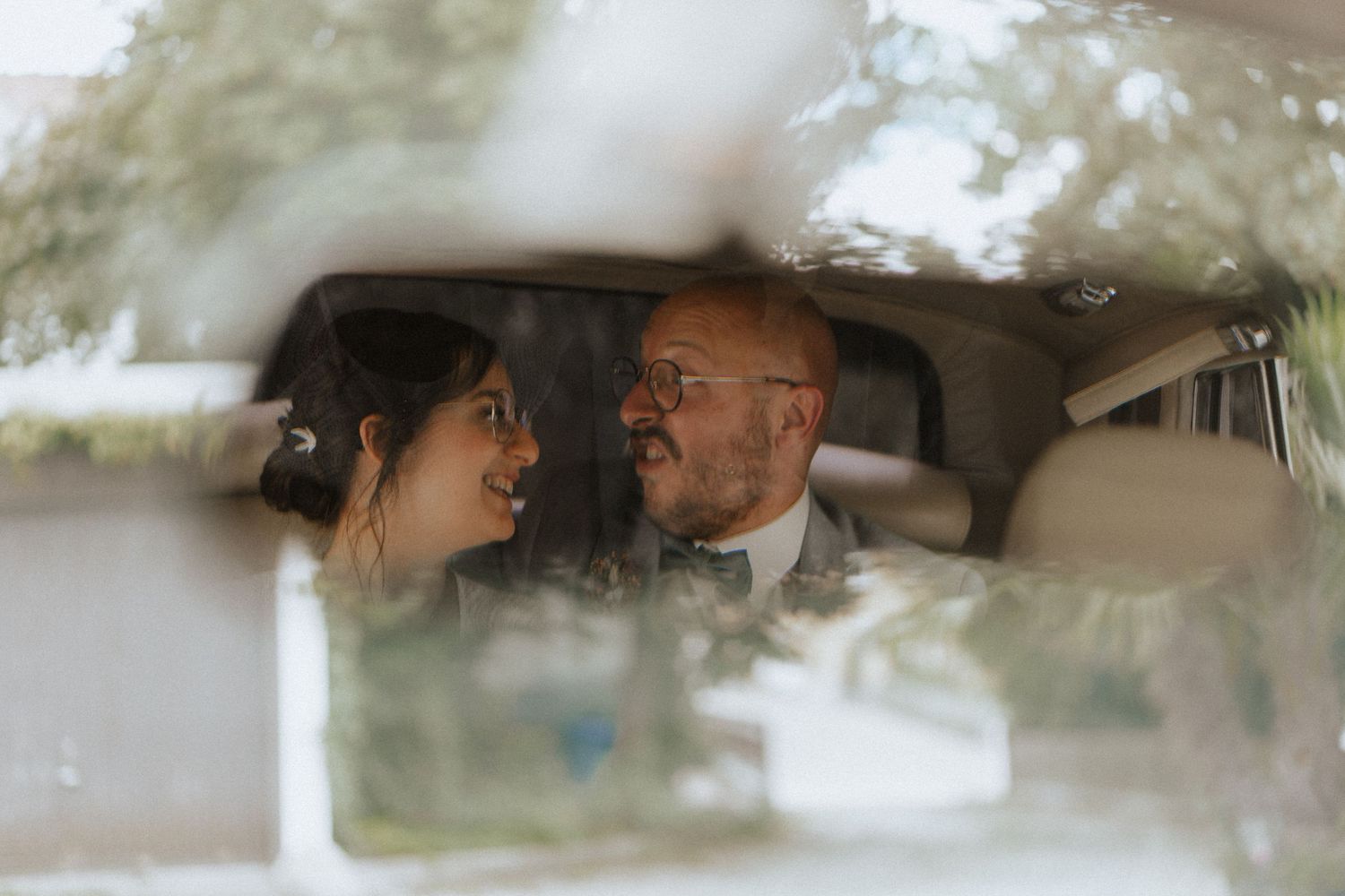 Seven identical film screenshots arranged horizontally show a couple embracing in a car backseat.