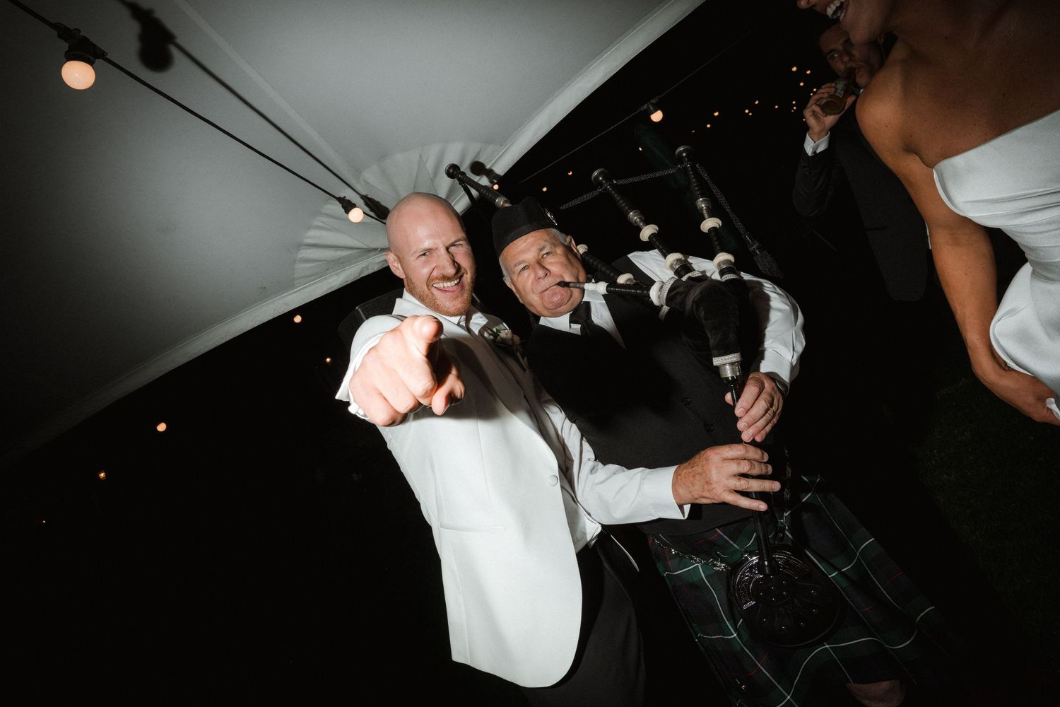 A festive party moment with confetti flying under tent lighting.