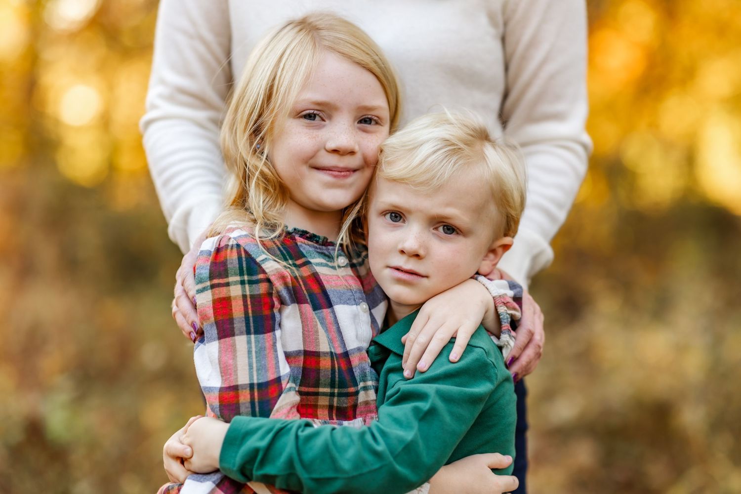 Big sister's plaid contains both the green and the white of her brother and mom's shirts