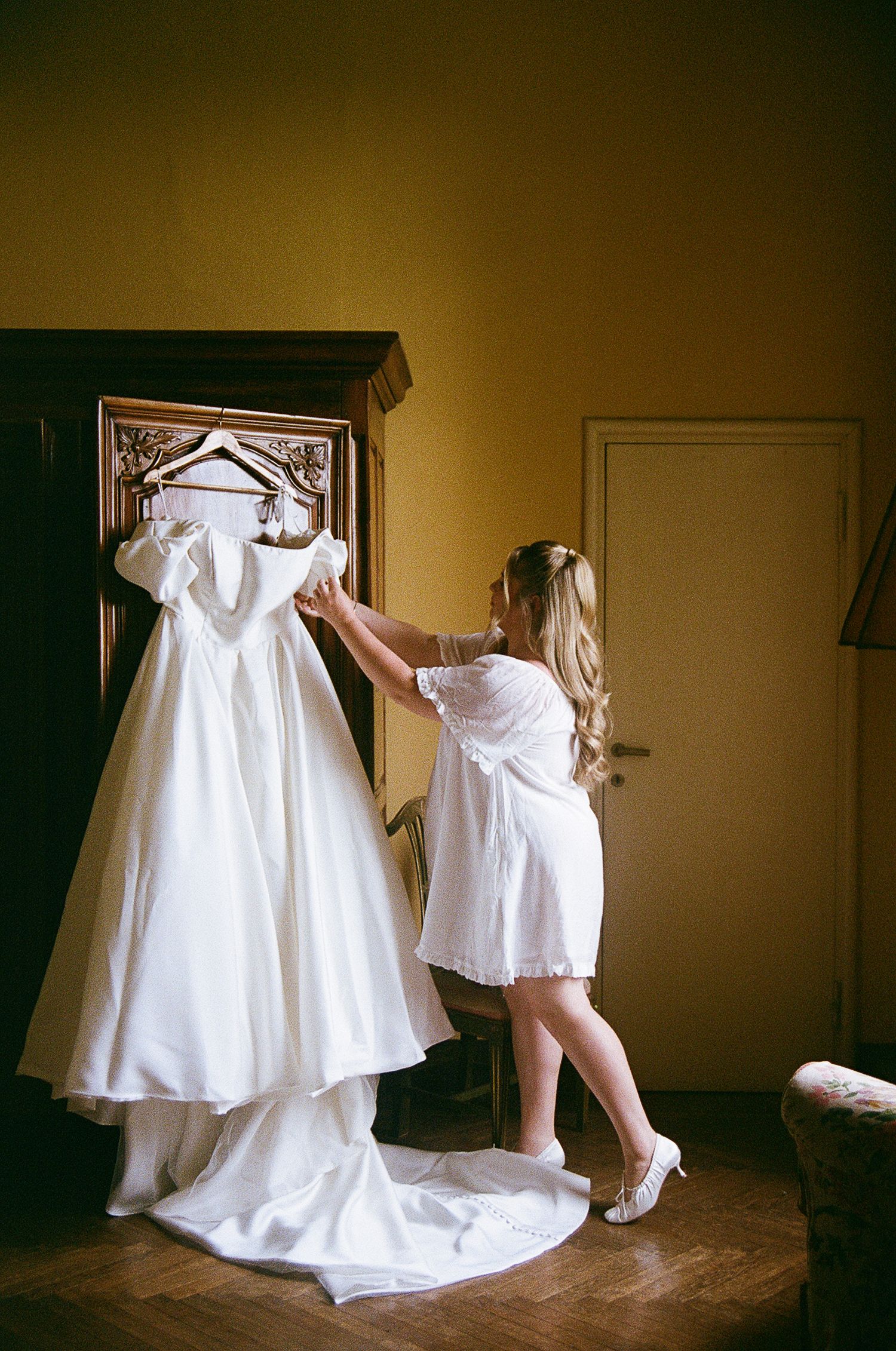 A series of artistic shots showing white wedding dresses being arranged in natural light.