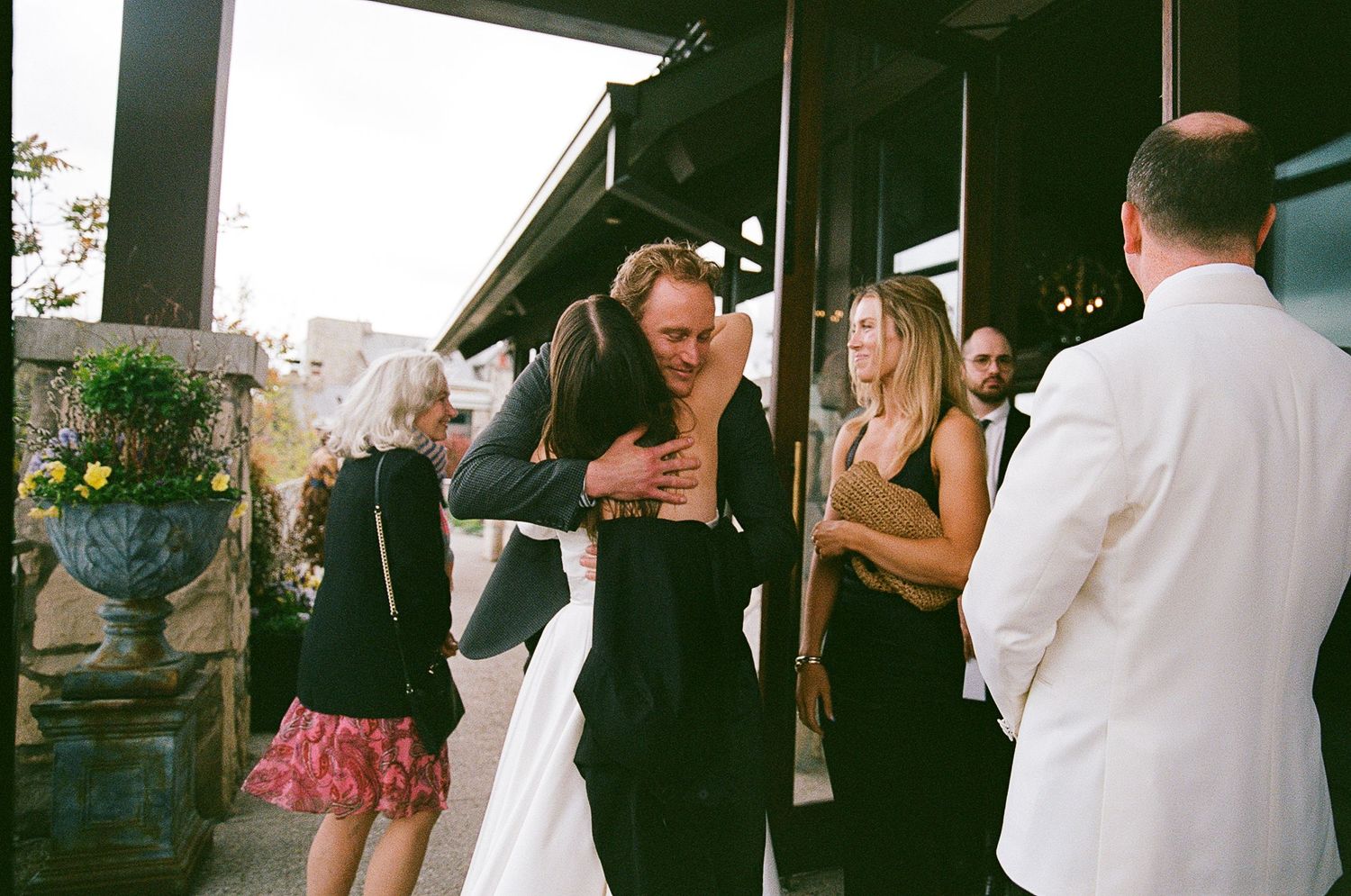 A strip of black and white film negative photos showing candid party or event moments in sequence.