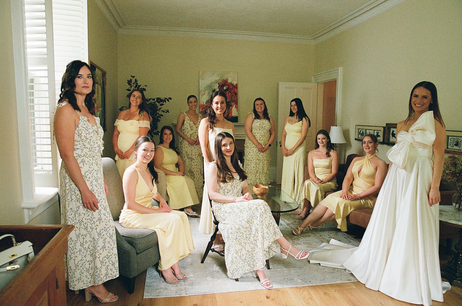 A panoramic collage of people in white and beige dresses gathered in a bright room during a pre-wedding celebration.