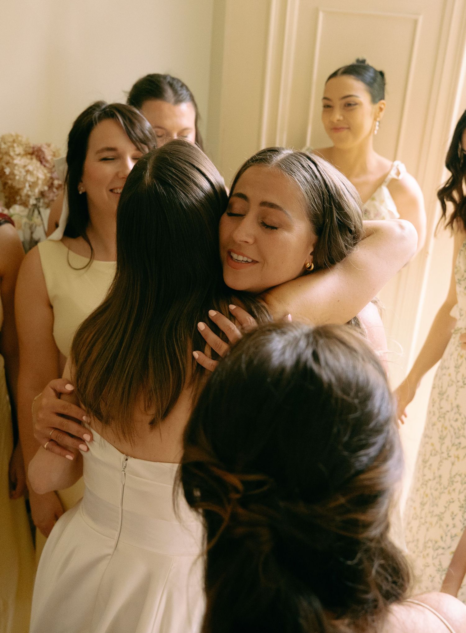 First look with bridesmaids in Cambridge home before wedding.