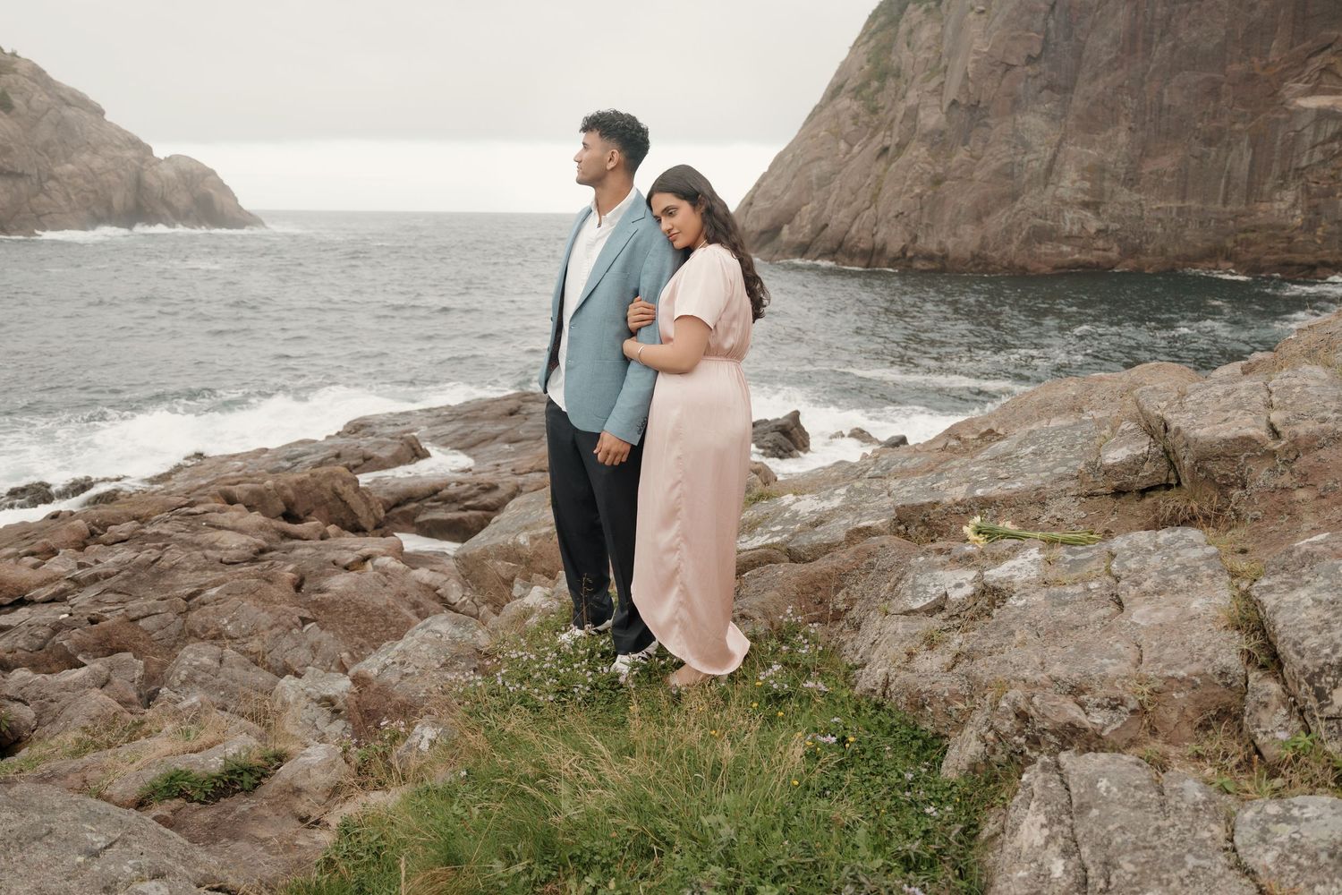 Creative engagement photos captured along rugged coastal rocks and cliffs.