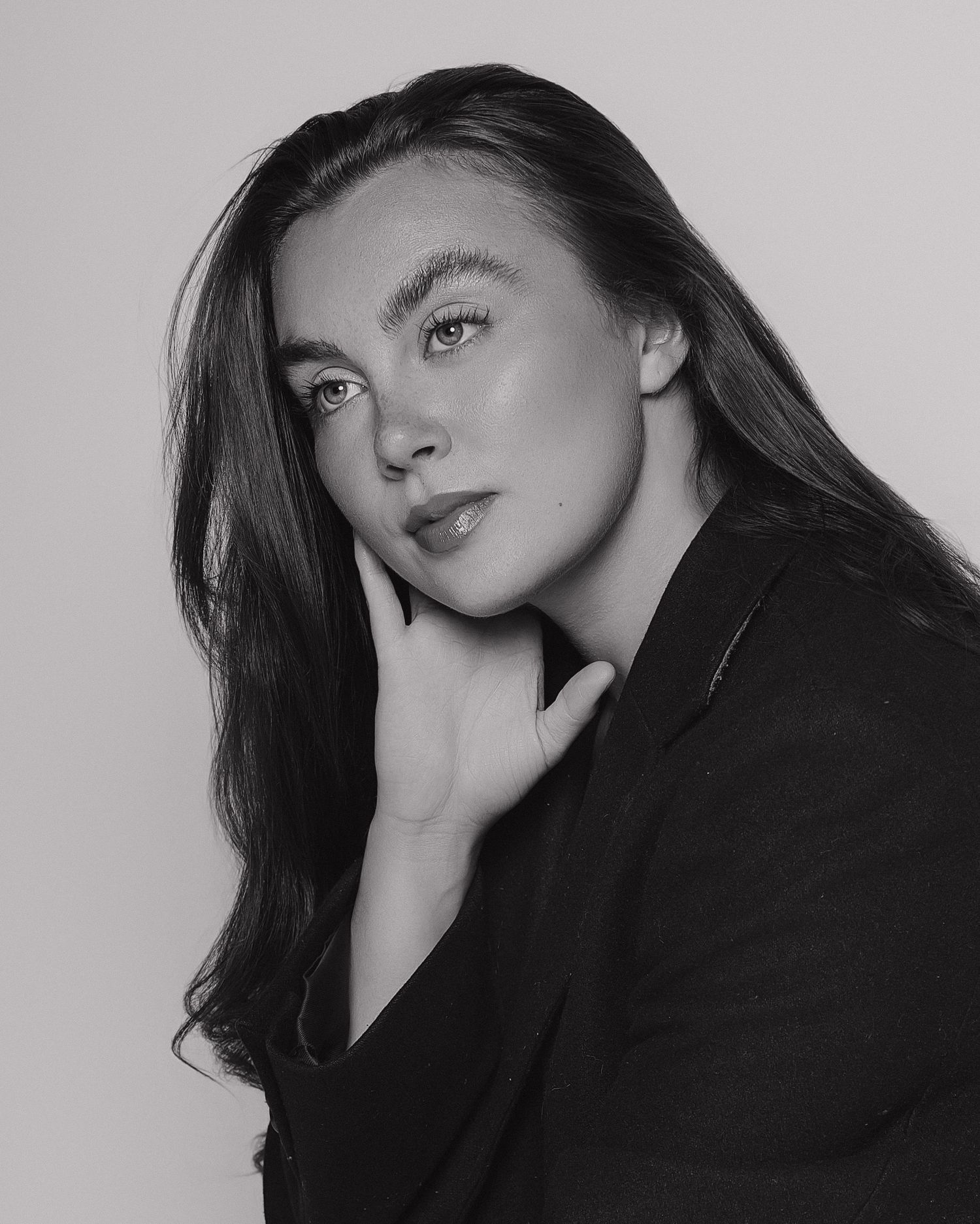 Artistic black and white portrait series showing dramatic lighting and shadows.