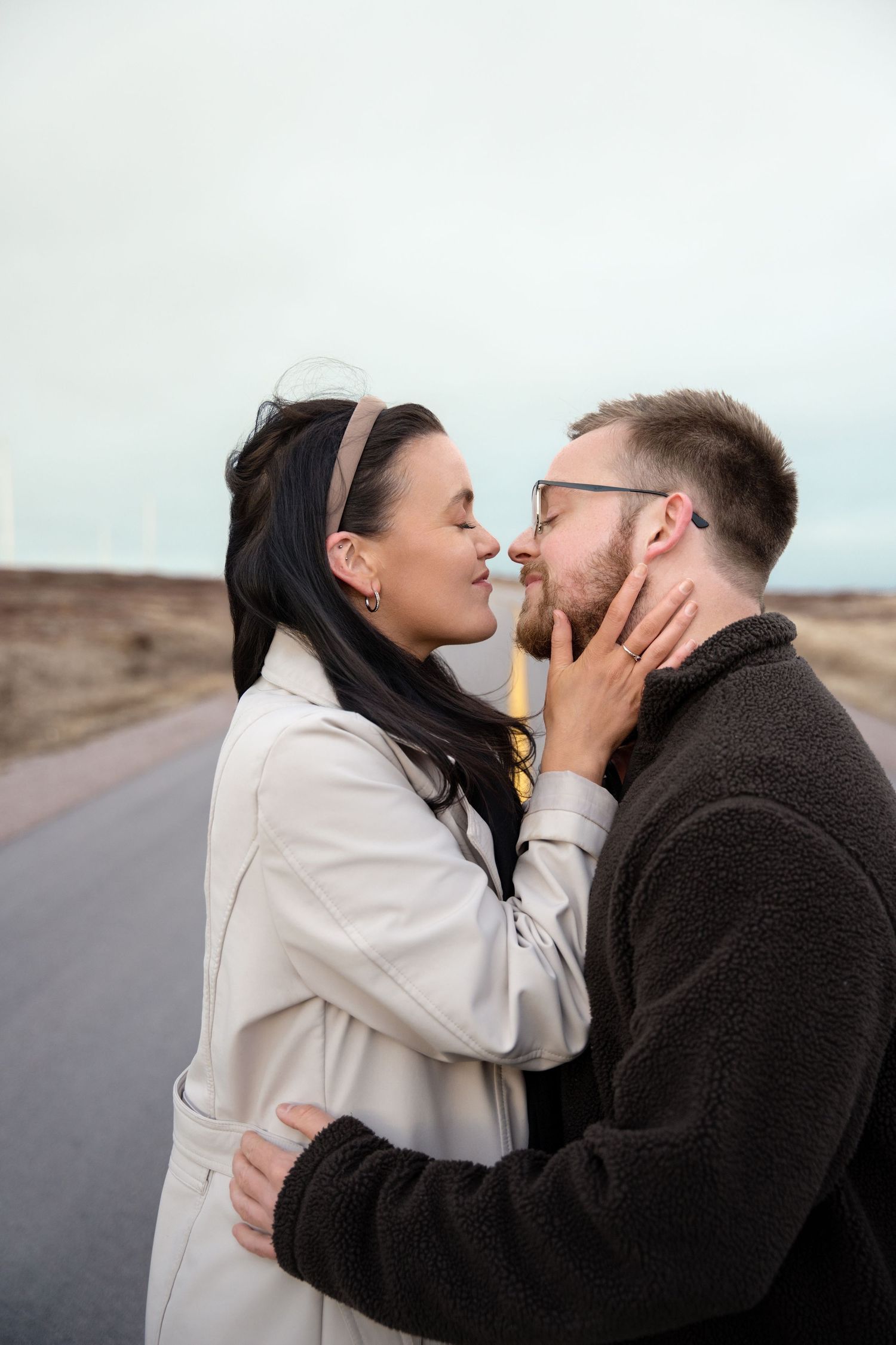 Intimate romantic moment shared between couple on desert road.