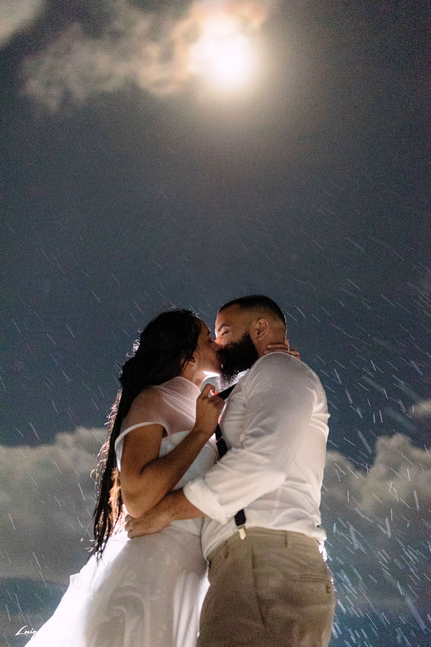 Romantic nighttime portrait under moonlit sky with starry effect.