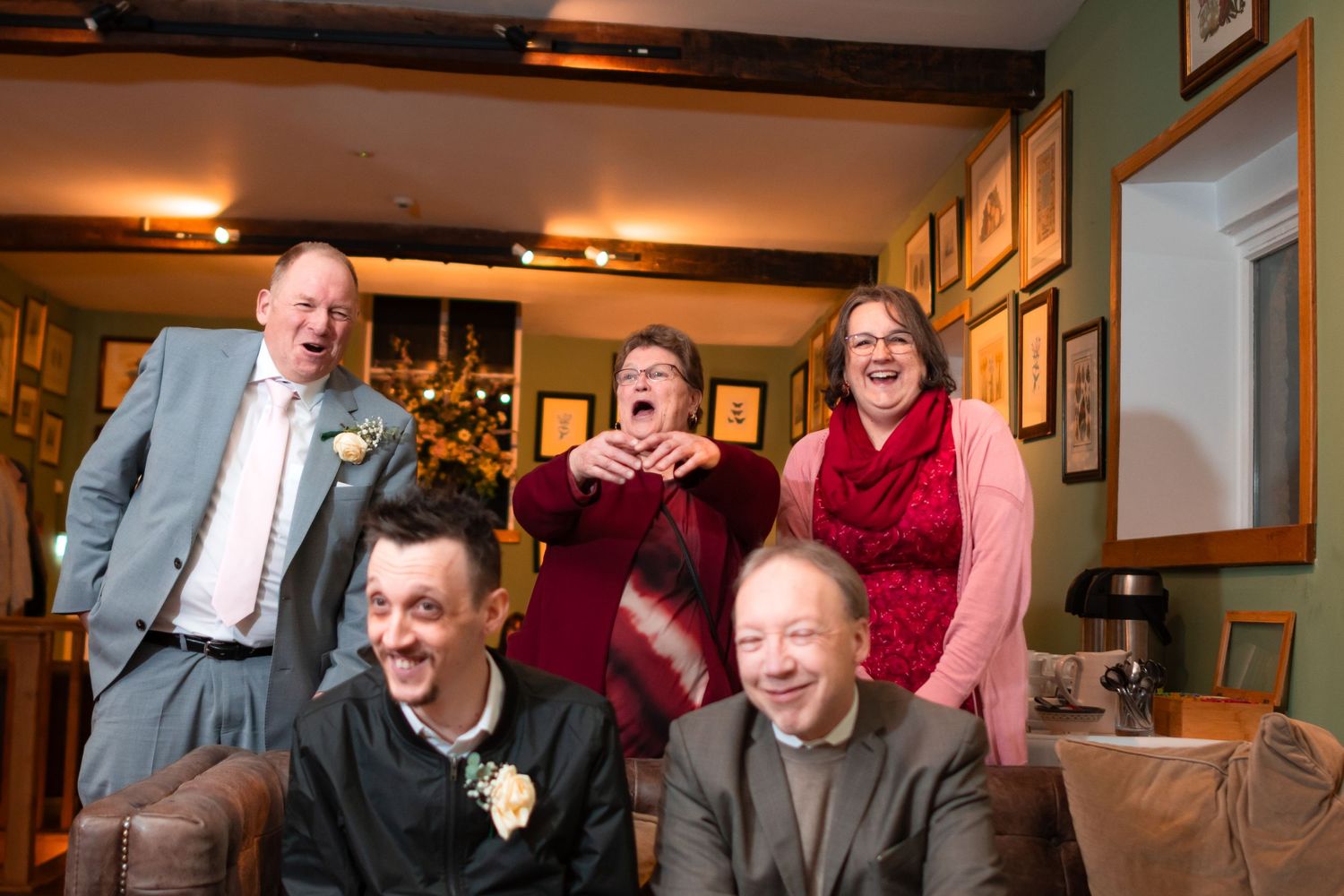 Candid moment of laughter and joy during an indoor celebration.
