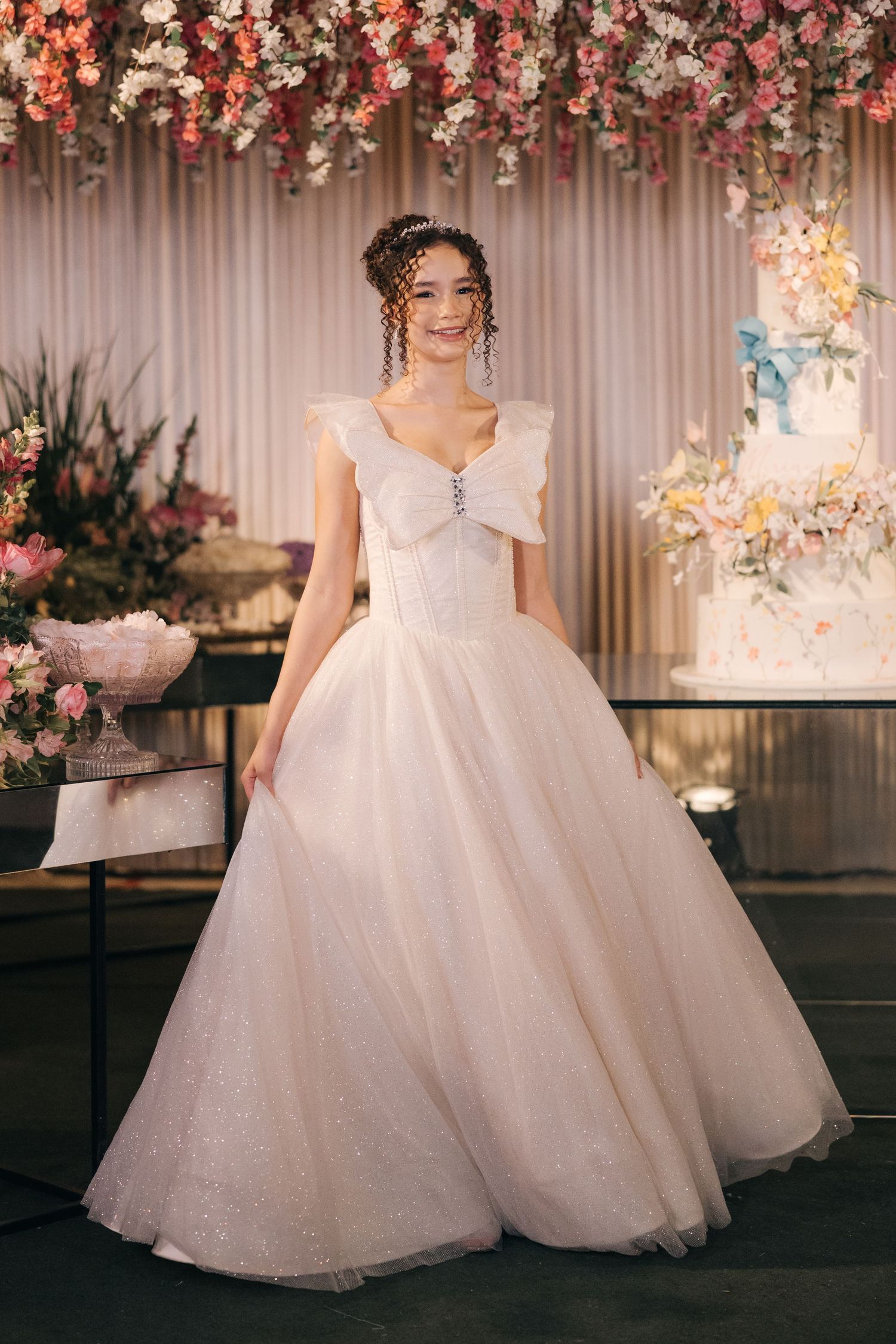 Romantic ballgown with fitted bodice and full tulle skirt displayed in elegant wedding venue setting.