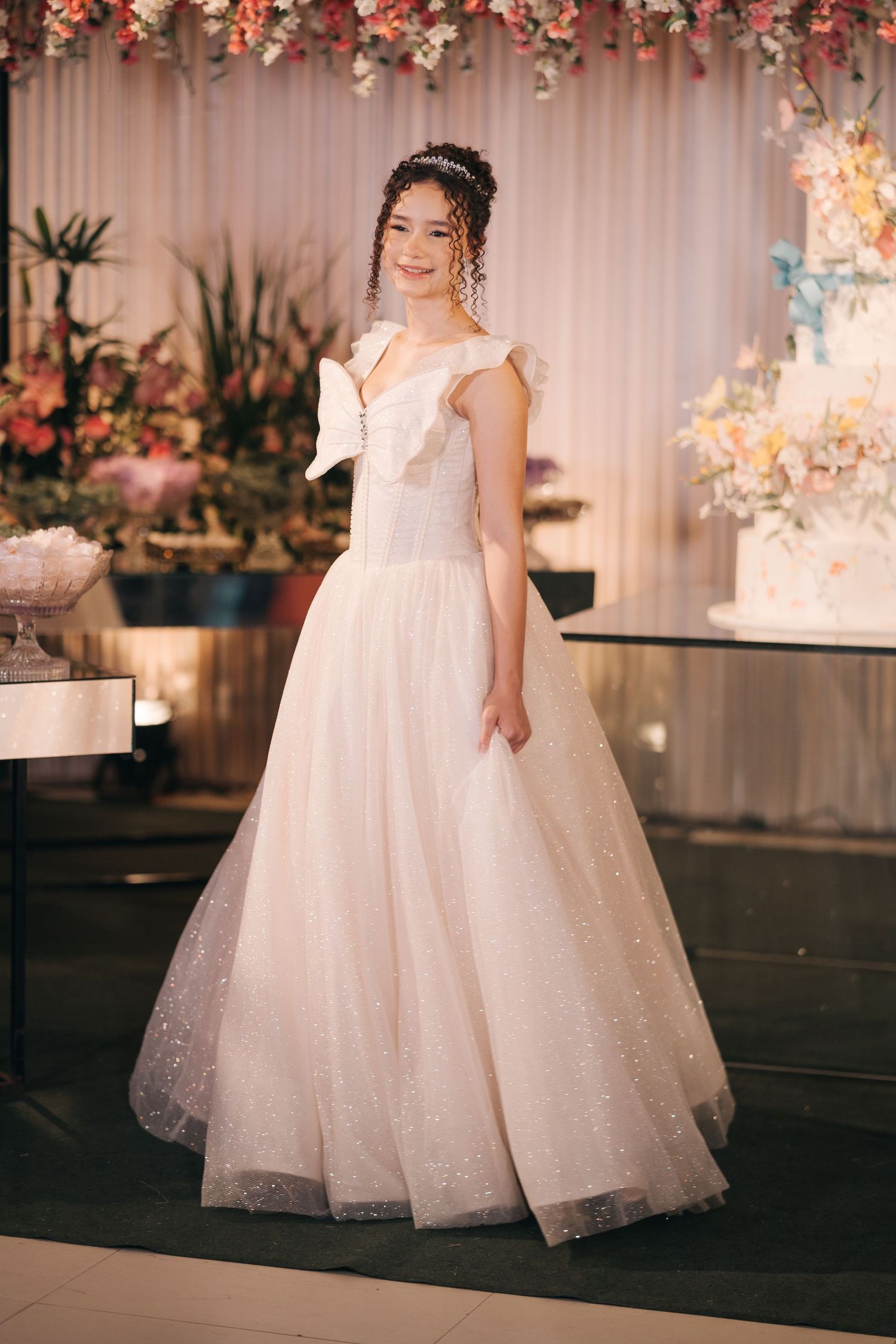 Full-length view of a princess-style wedding dress with sparkly tulle and cap sleeves.