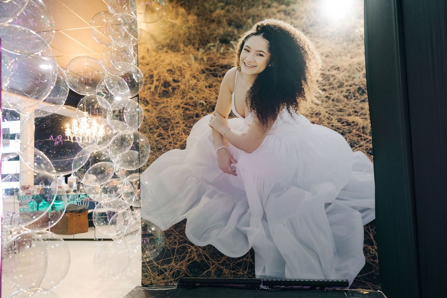 A dreamy portrait featuring a white tulle gown against a warm-toned artistic background.