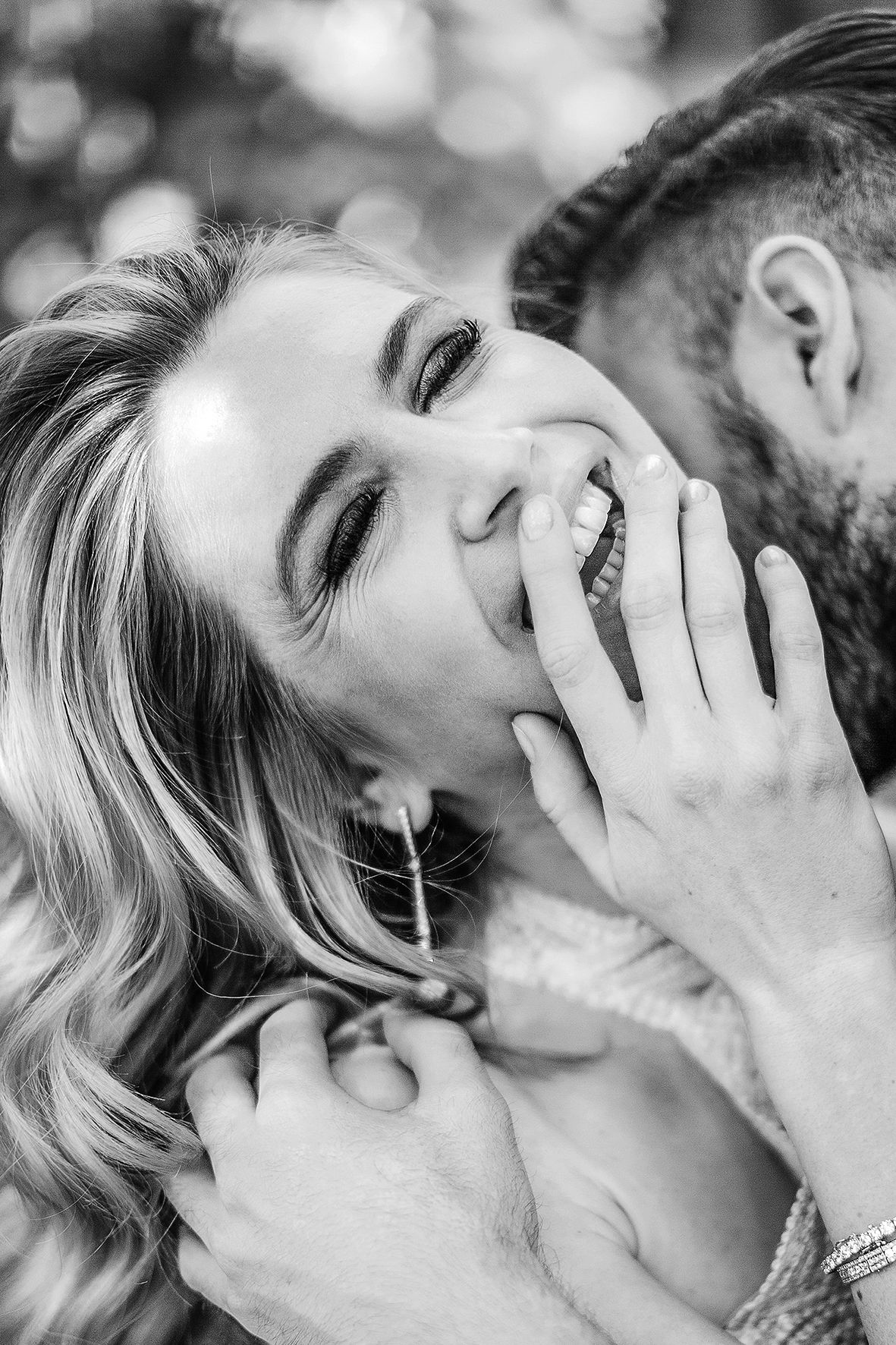 Intimate black and white portrait capturing candid laughter between couple.
