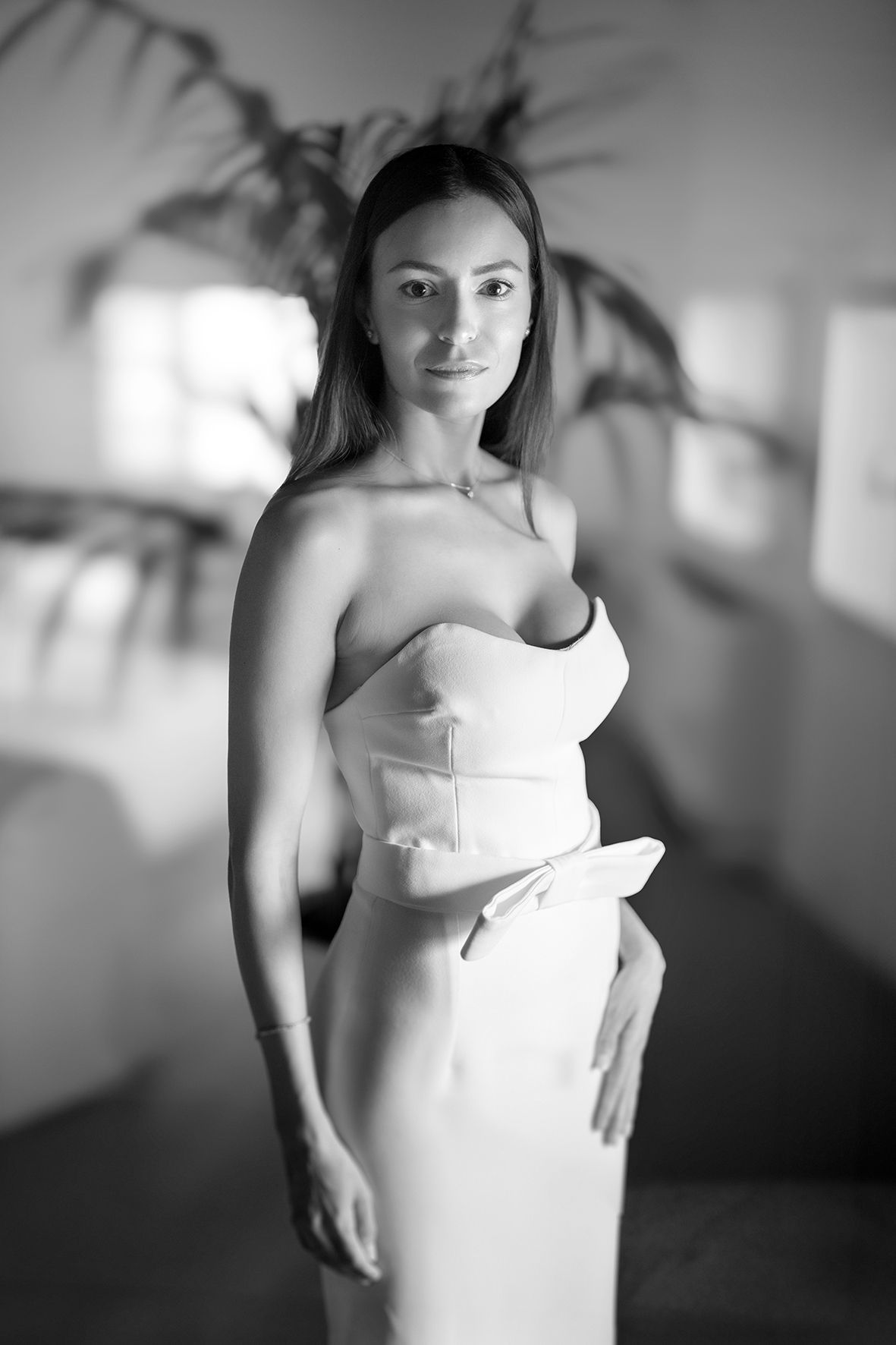 Black and white artistic photo series showing a woman wearing a white dress in soft focus with different poses.