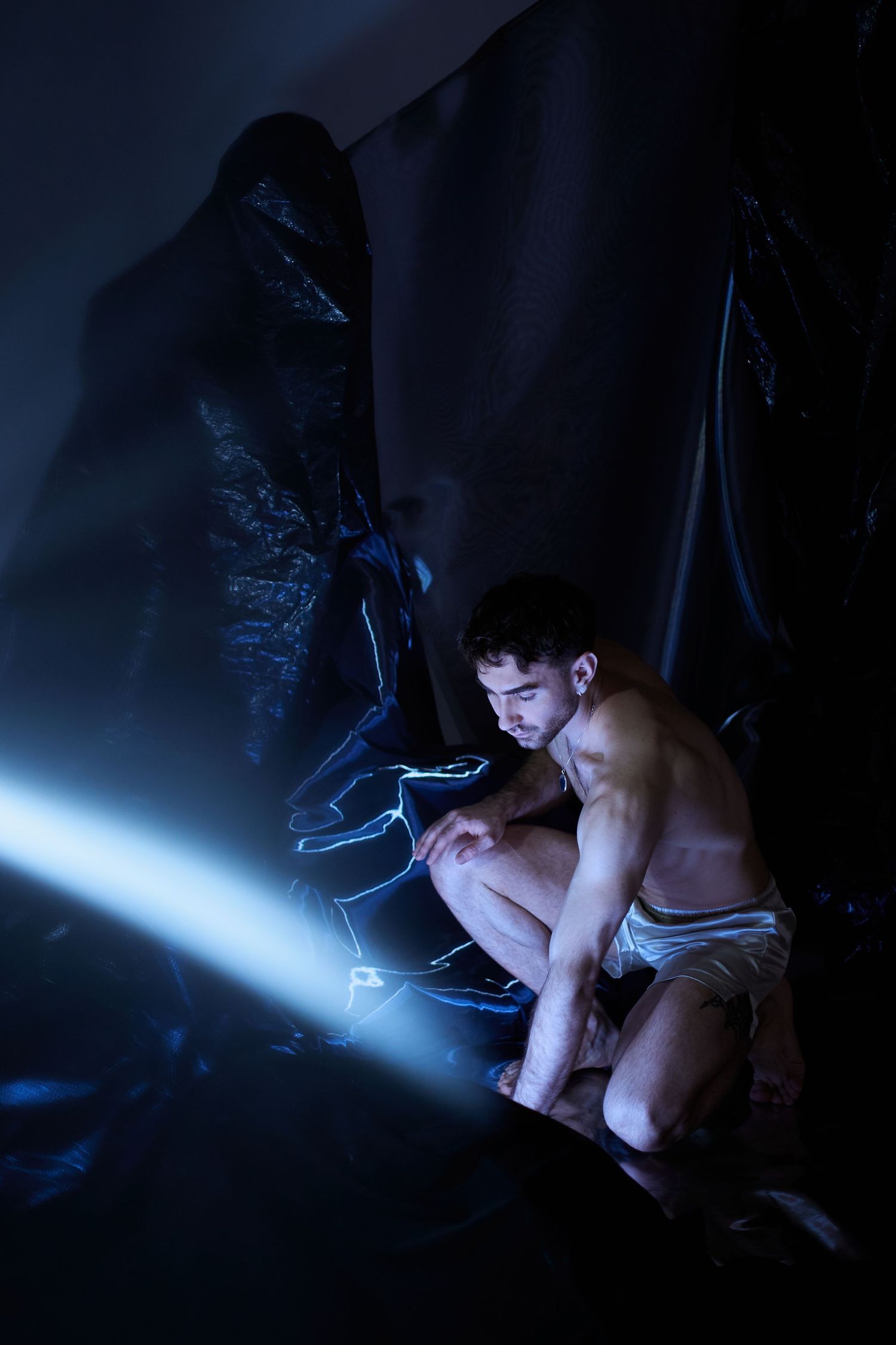 Person illuminated by blue screen glow in dark room creates dramatic lighting sequence across multiple frames.