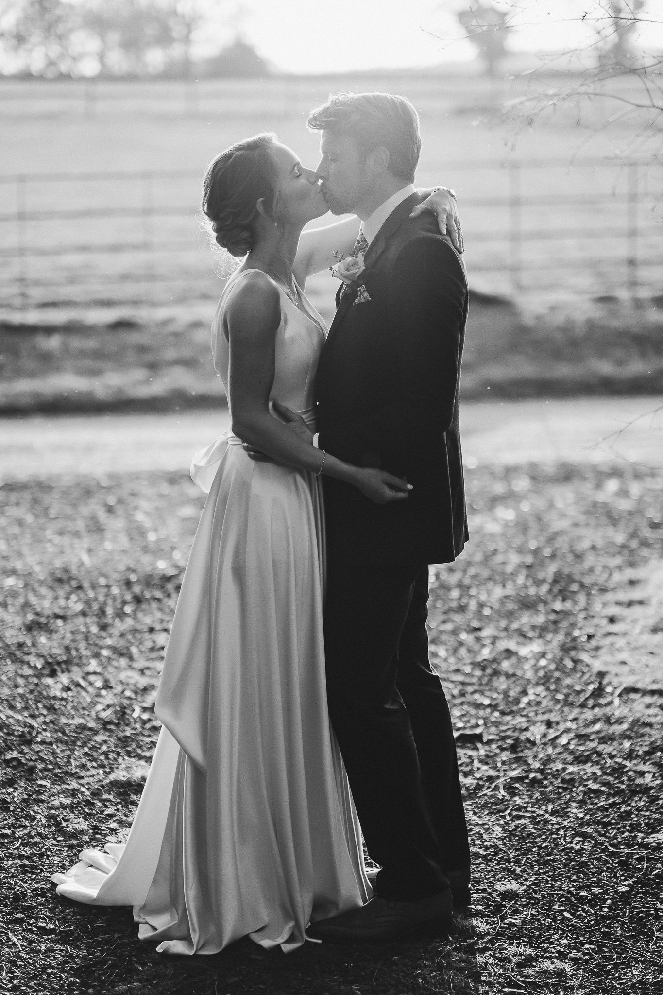 Black and white portrait shows tender moment between newlyweds on their wedding day.