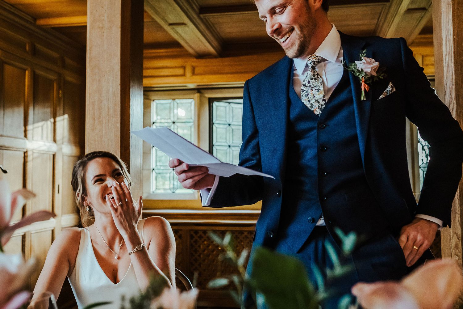 Candid wedding reception moments captured in rustic wooden interior with natural lighting.