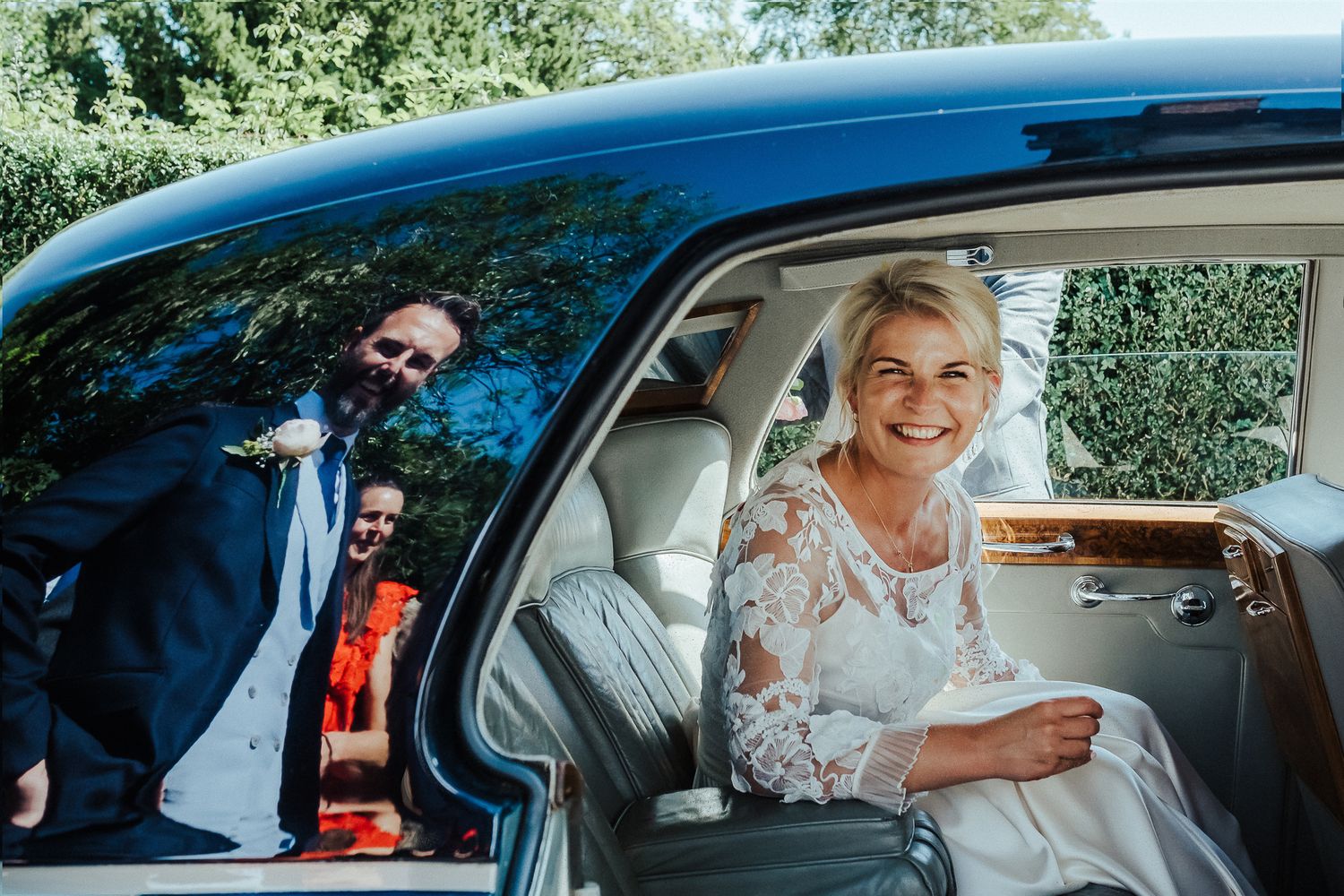 Wedding party arriving in vintage cars on a sunny summer day.