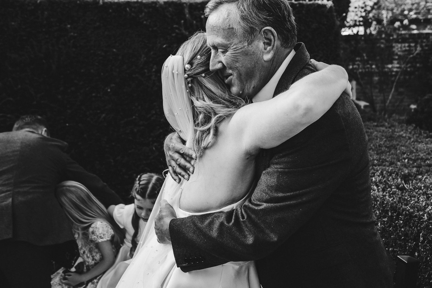 Black and white photos capturing intimate moments between wedding attendees.