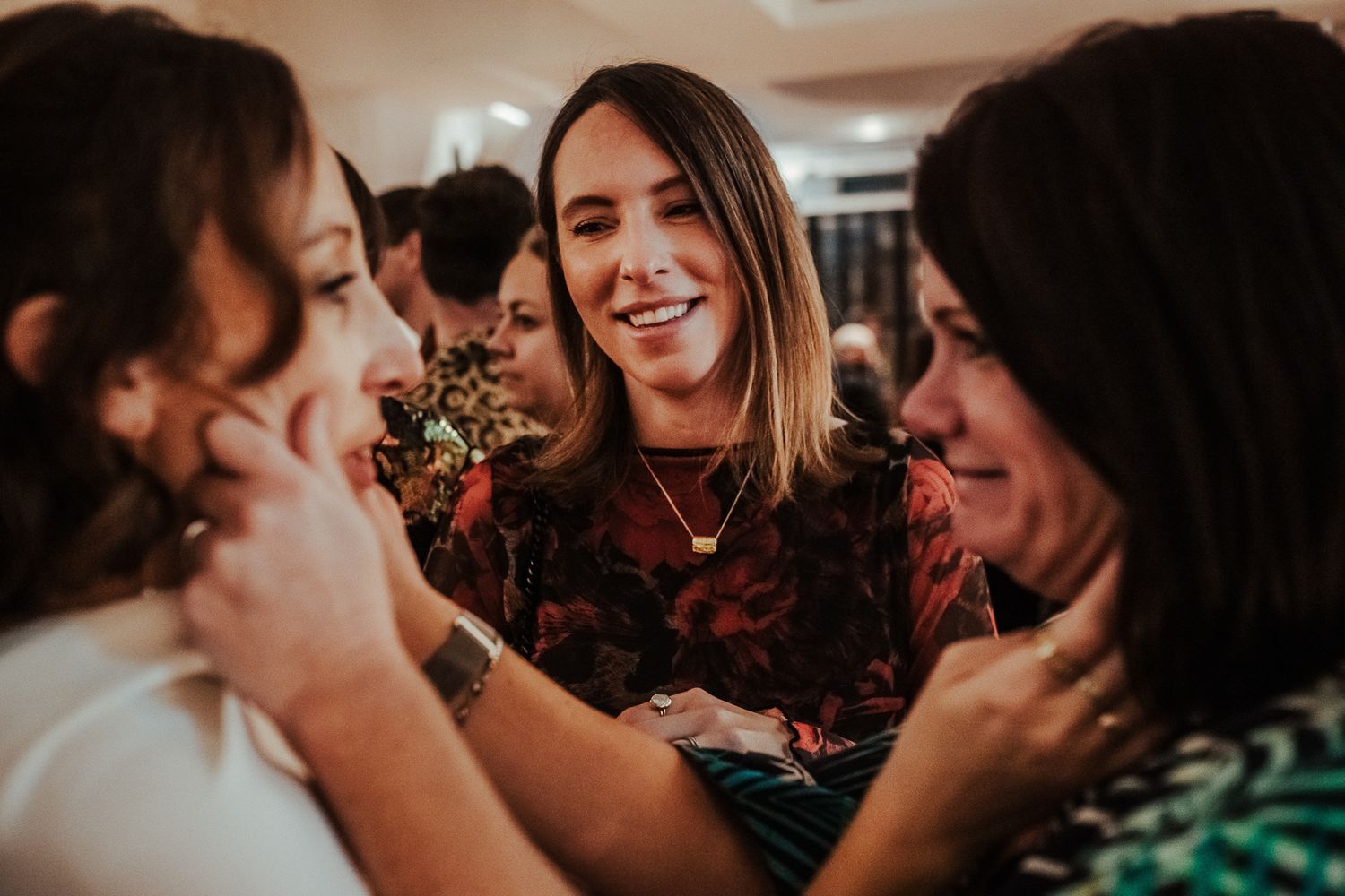 Group of friends sharing genuine laughter at a social gathering.