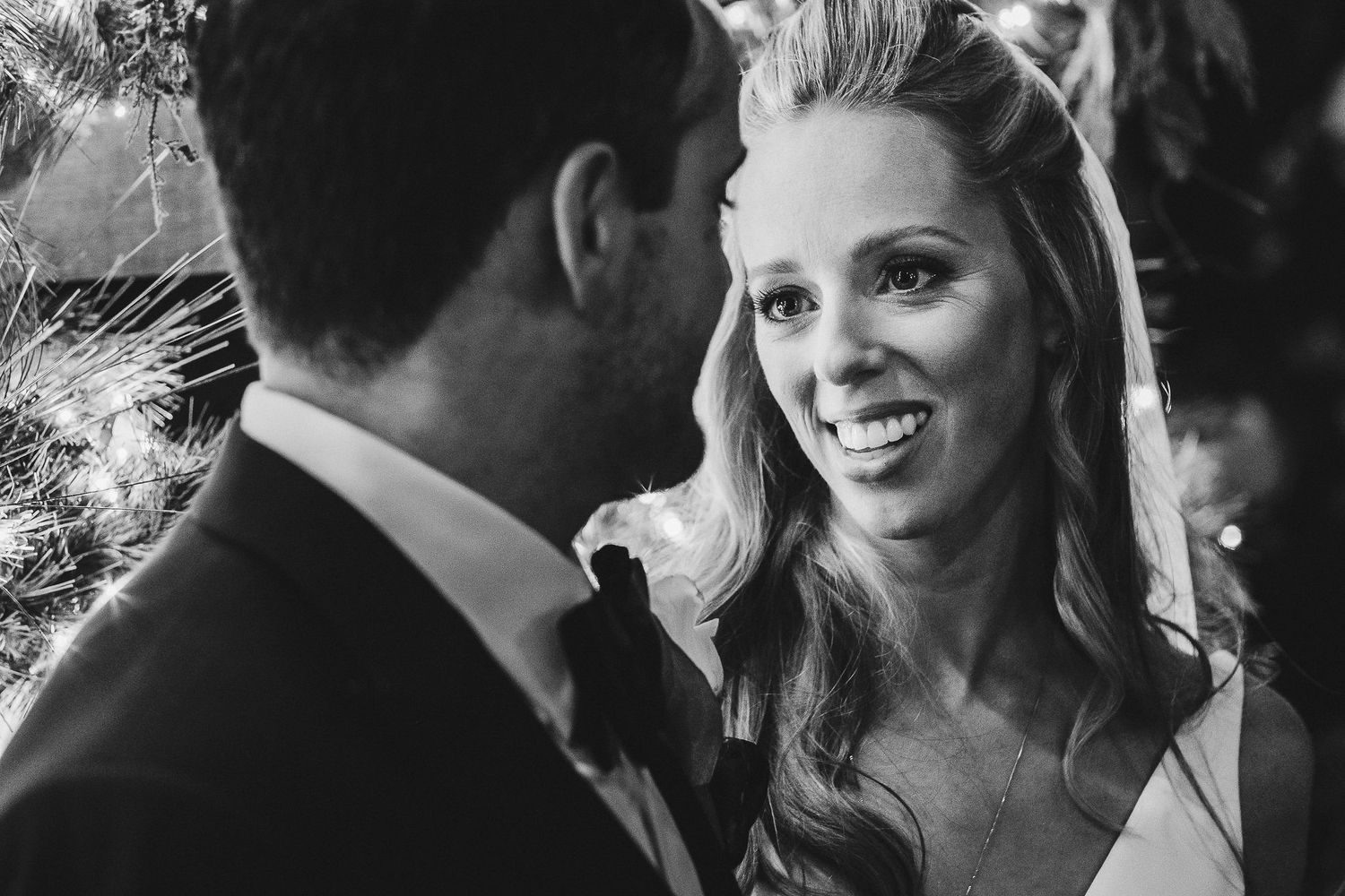 Black and white intimate moment captured during wedding celebration.