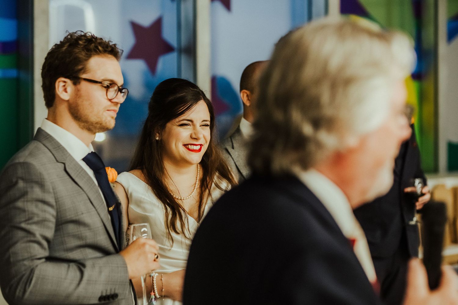 Wedding reception scene with colorful star decorations and natural lighting.