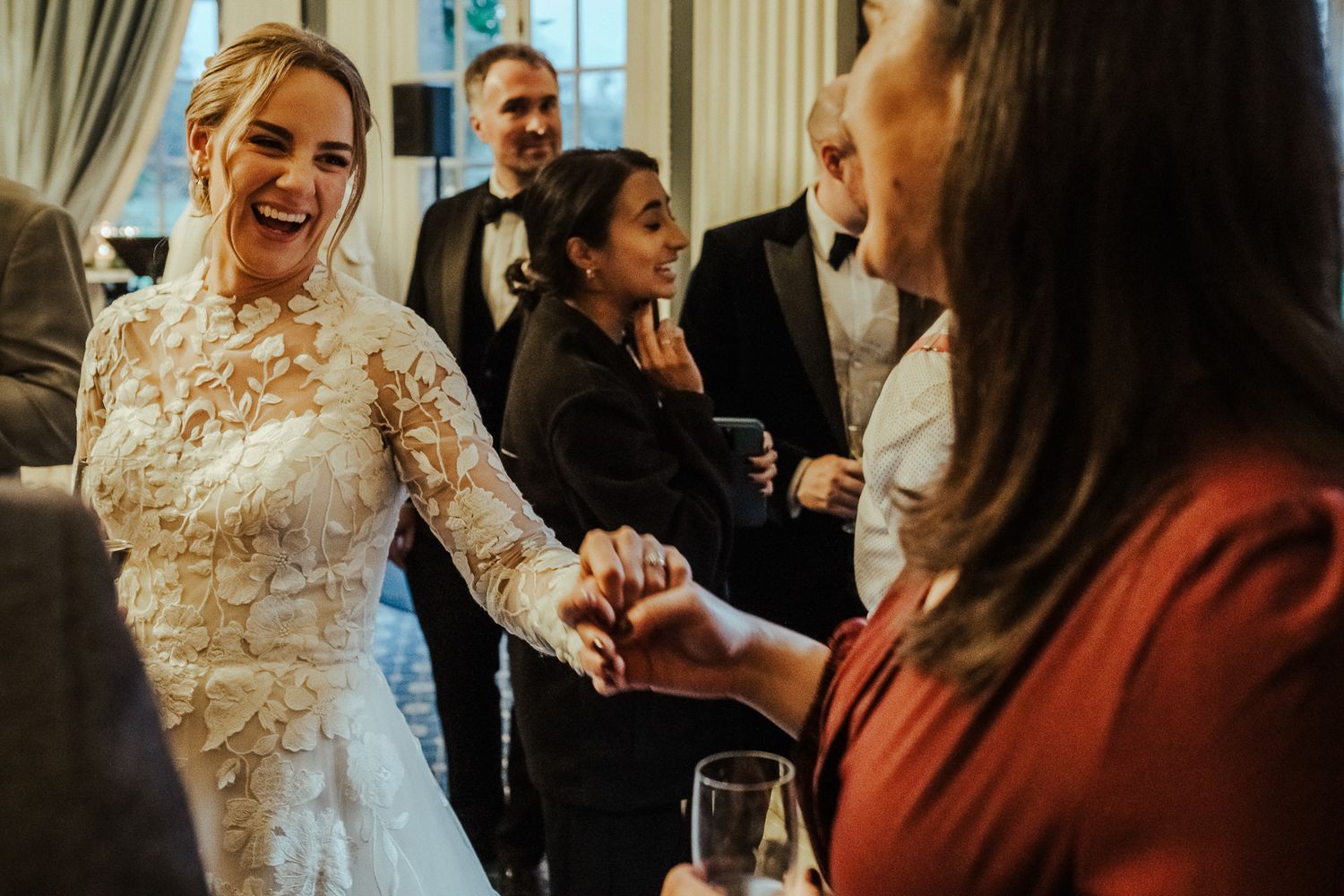 Wedding reception captures joyful moments between guests and bride.