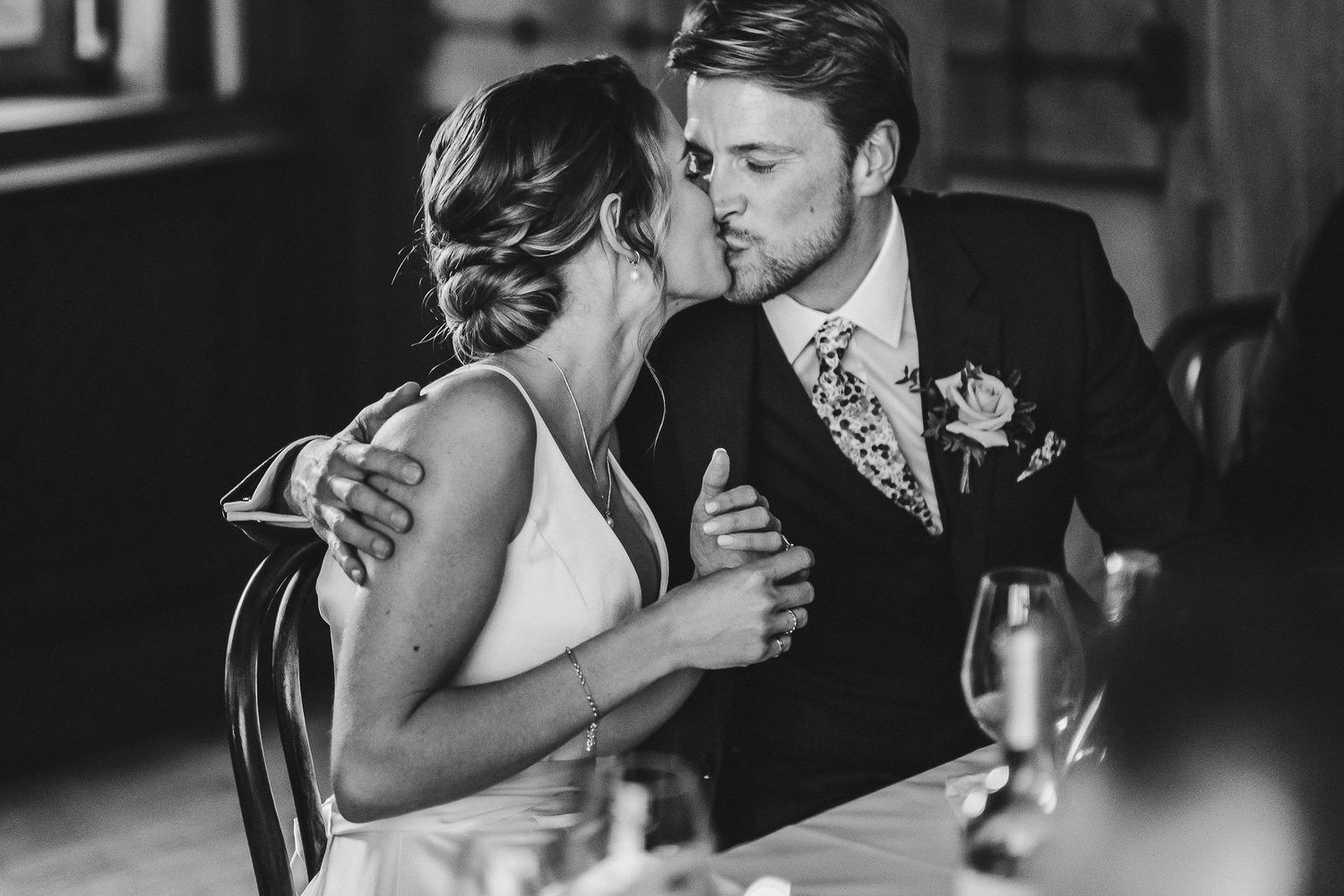Dramatic black and white wedding portraits with candlelight creating romantic atmosphere.